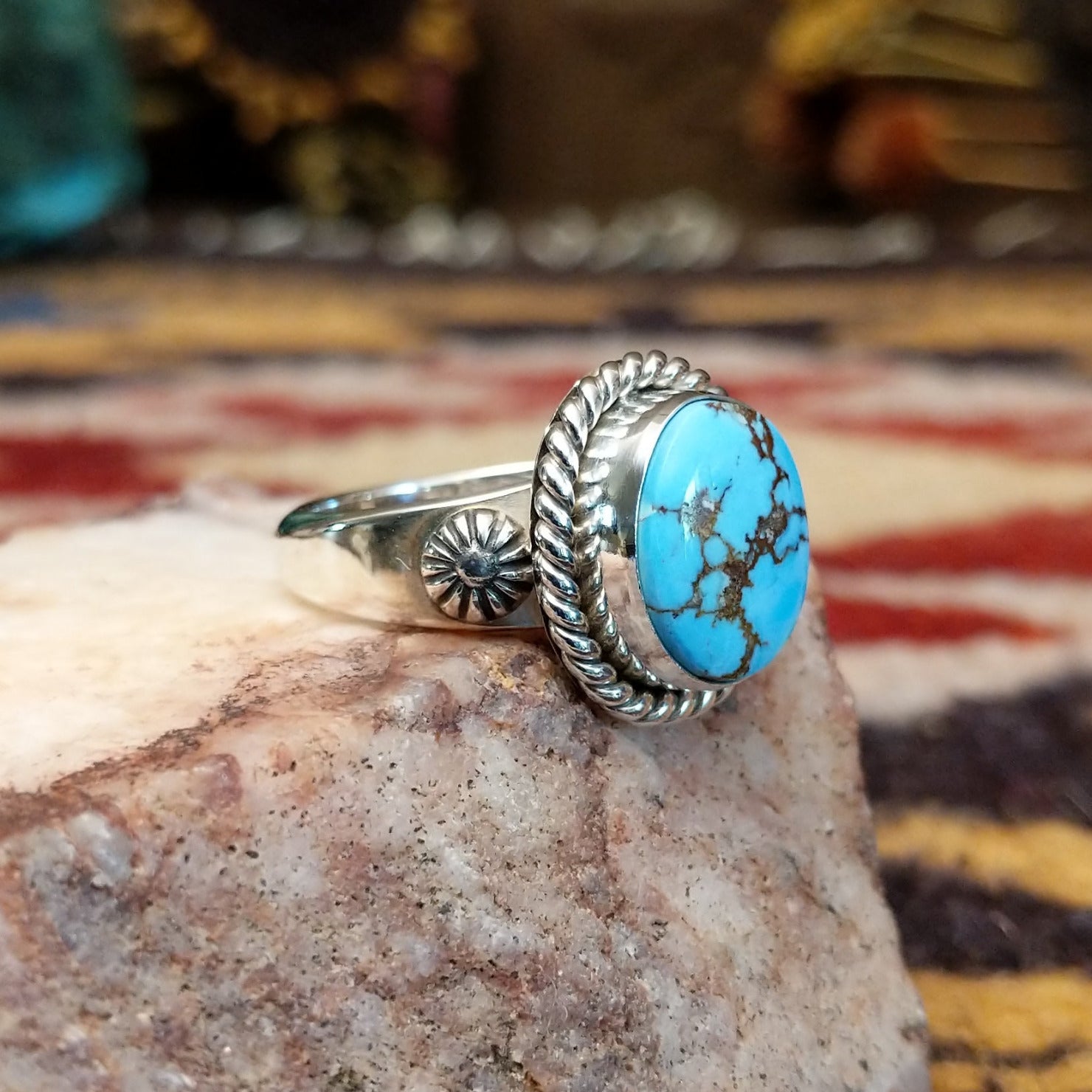 Handcrafted sterling silver circle ring by Artie Yellowhorse featuring a round Golden Hills turquoise stone in a polished Southwestern Native American design. Side view.