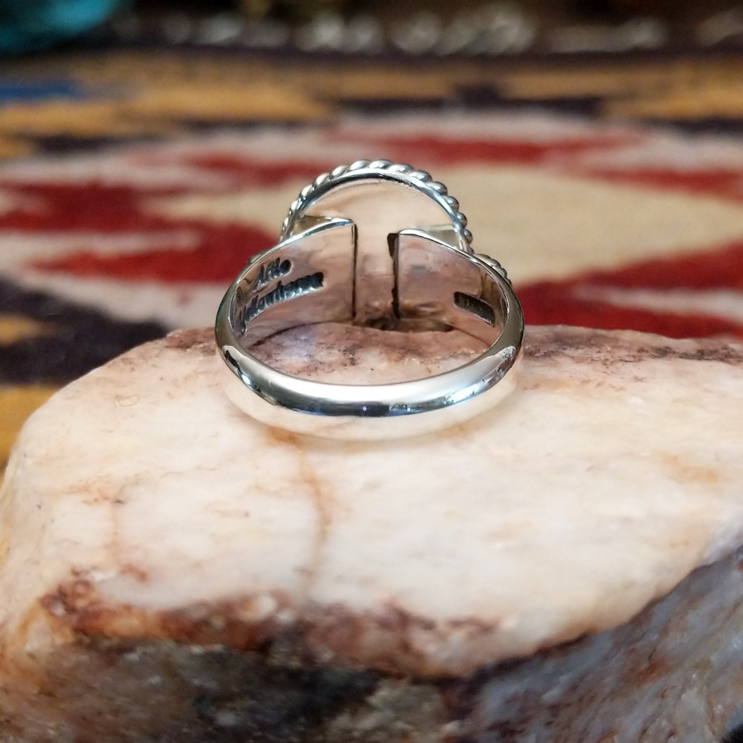 Handcrafted sterling silver circle ring by Artie Yellowhorse featuring a round Golden Hills turquoise stone in a polished Southwestern Native American design. Underside view.