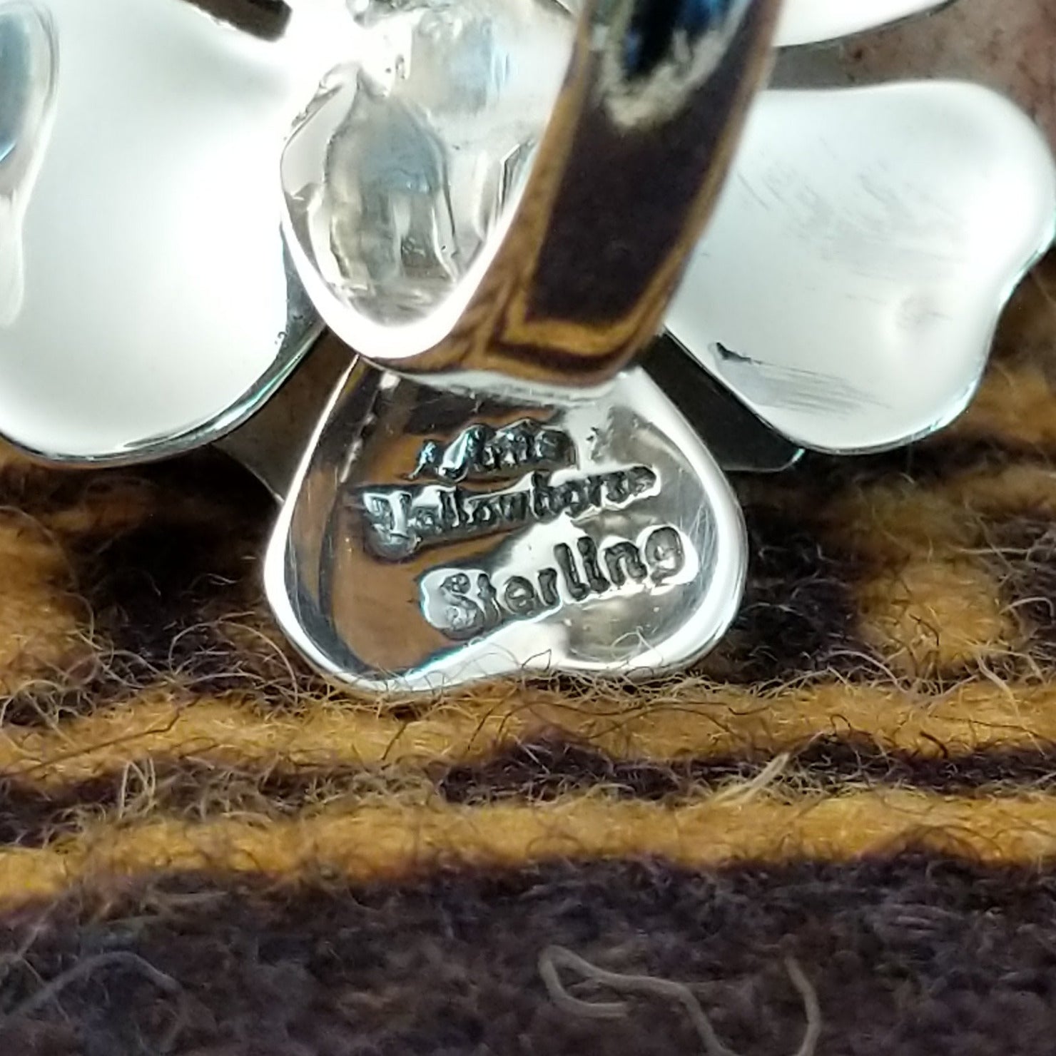 Handcrafted sterling silver dogwood flower ring by Artie Yellowhorse featuring polished floral detailing in a Southwestern Native American design. Artisan and Sterling Silver stamp.