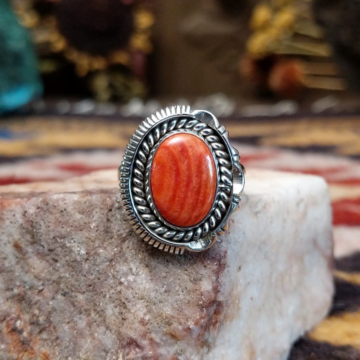 Handcrafted sterling silver oval ring by Artie Yellowhorse featuring a red spiny oyster shell in a polished Southwestern Native American design.