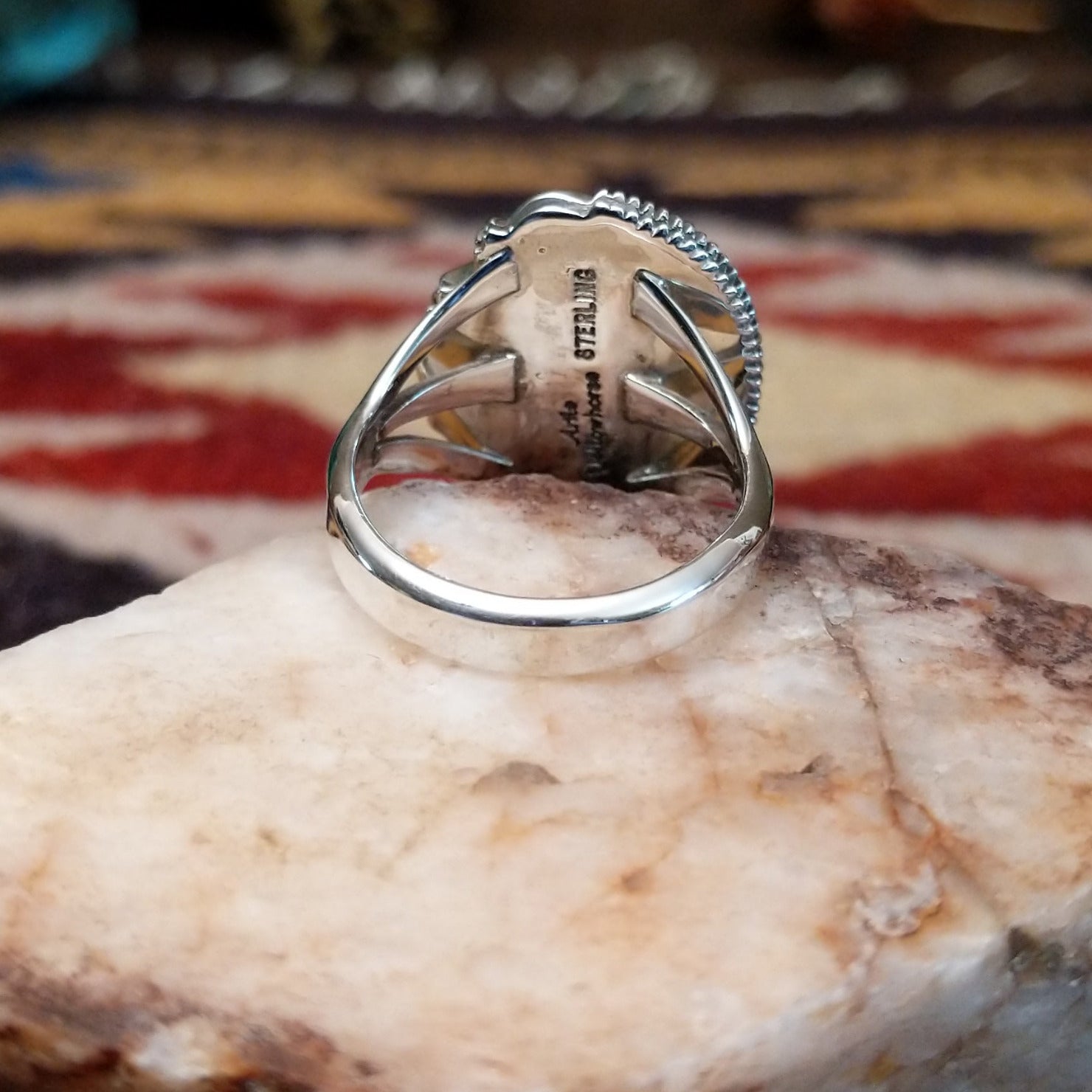Handcrafted sterling silver oval ring by Artie Yellowhorse featuring a deep blue lapis stone in a polished Southwestern Native American design. Underside view.