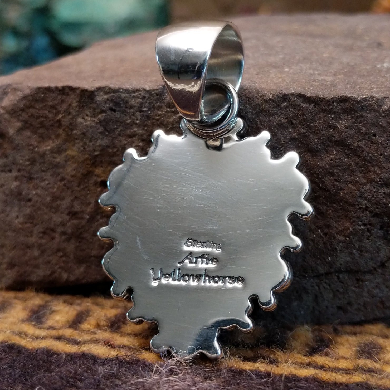 Handcrafted sterling silver pendant by Artie Yellowhorse featuring a Golden Hills turquoise stone in a polished Southwestern Native American design. Back view showcasing artisan and Sterling Silver stamp.