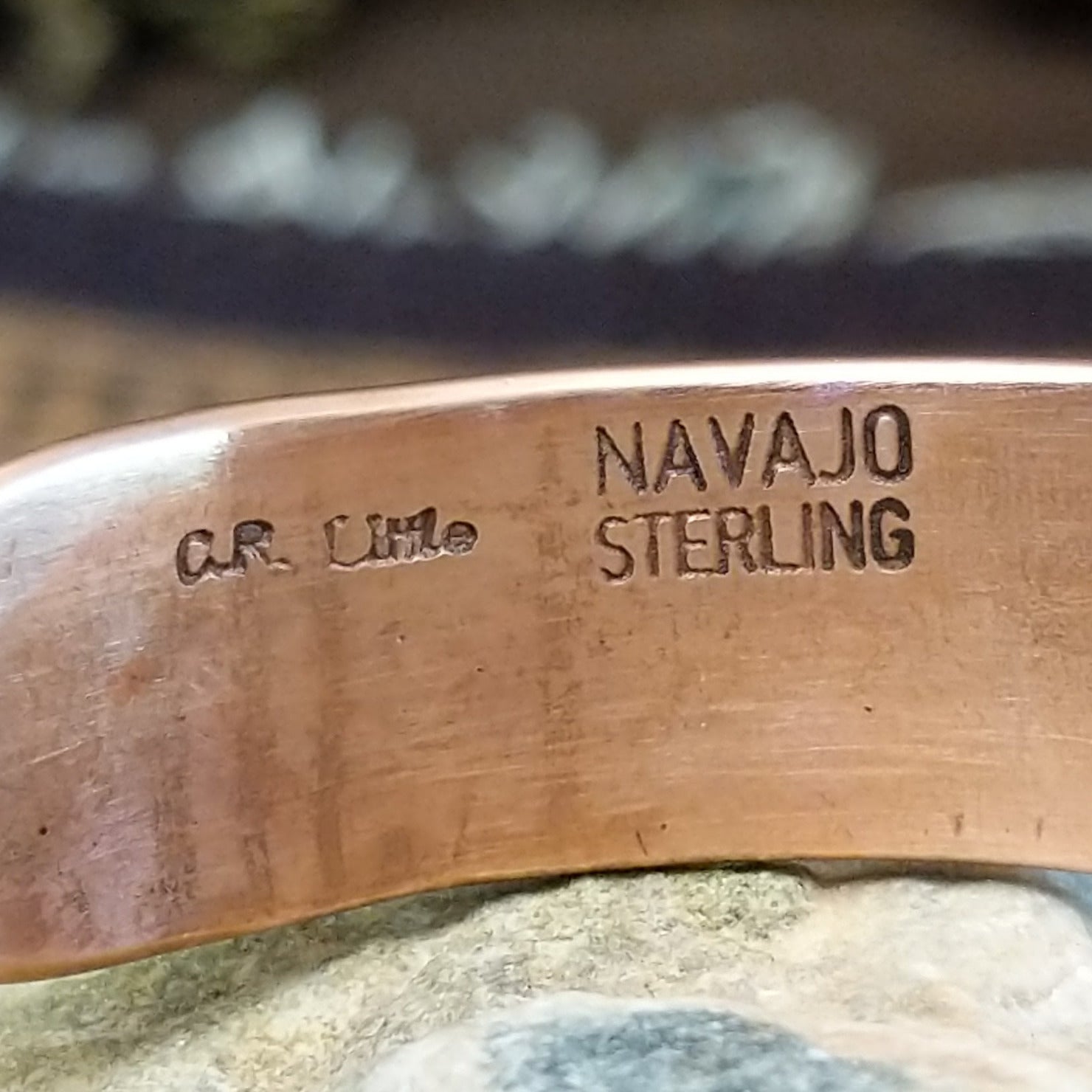 Handcrafted copper and sterling silver cuff bracelet by Navajo artisan Robert Little featuring wavy stamped detailing in a traditional Southwestern design. Artisan and Sterling Silver stamp.