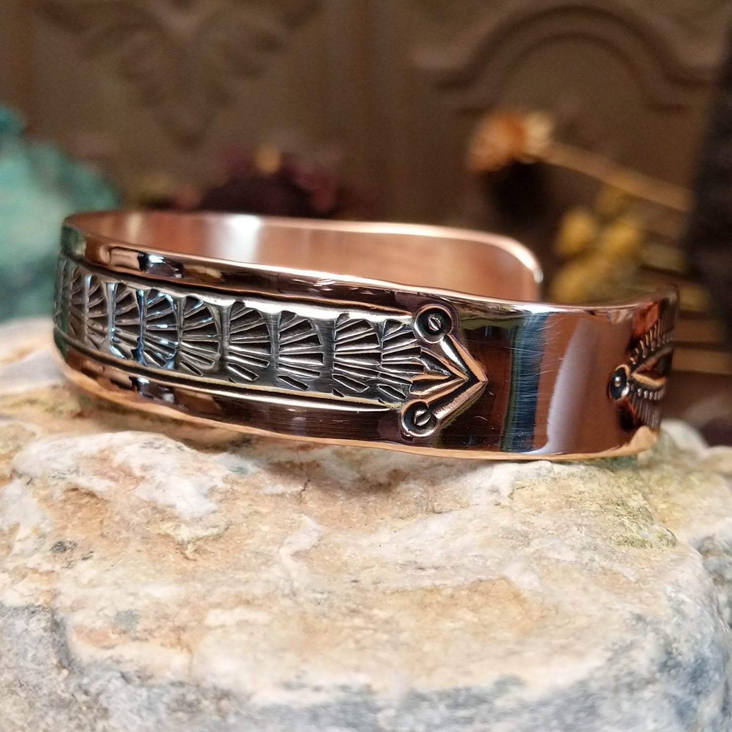 Handcrafted copper and sterling silver cuff bracelet by Navajo artisan Robert Little featuring fan-stamped detailing in a traditional Southwestern design. Side view.