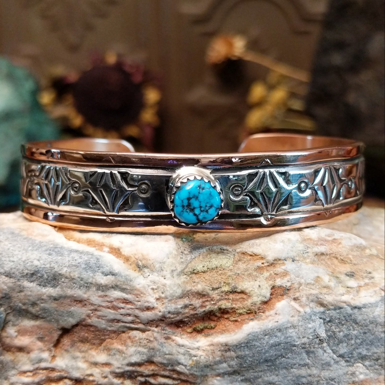 Handcrafted copper and sterling silver cuff bracelet by Navajo artisan Robert Little featuring a turquoise stone and traditional stamped detailing in a Southwestern design.