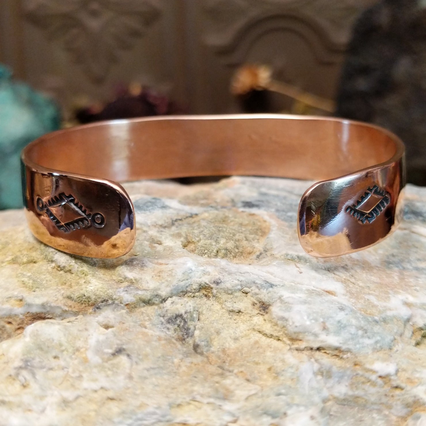 Handcrafted copper and sterling silver cuff bracelet by Navajo artisan Robert Little featuring a turquoise stone and traditional stamped detailing in a Southwestern design. Underside view.