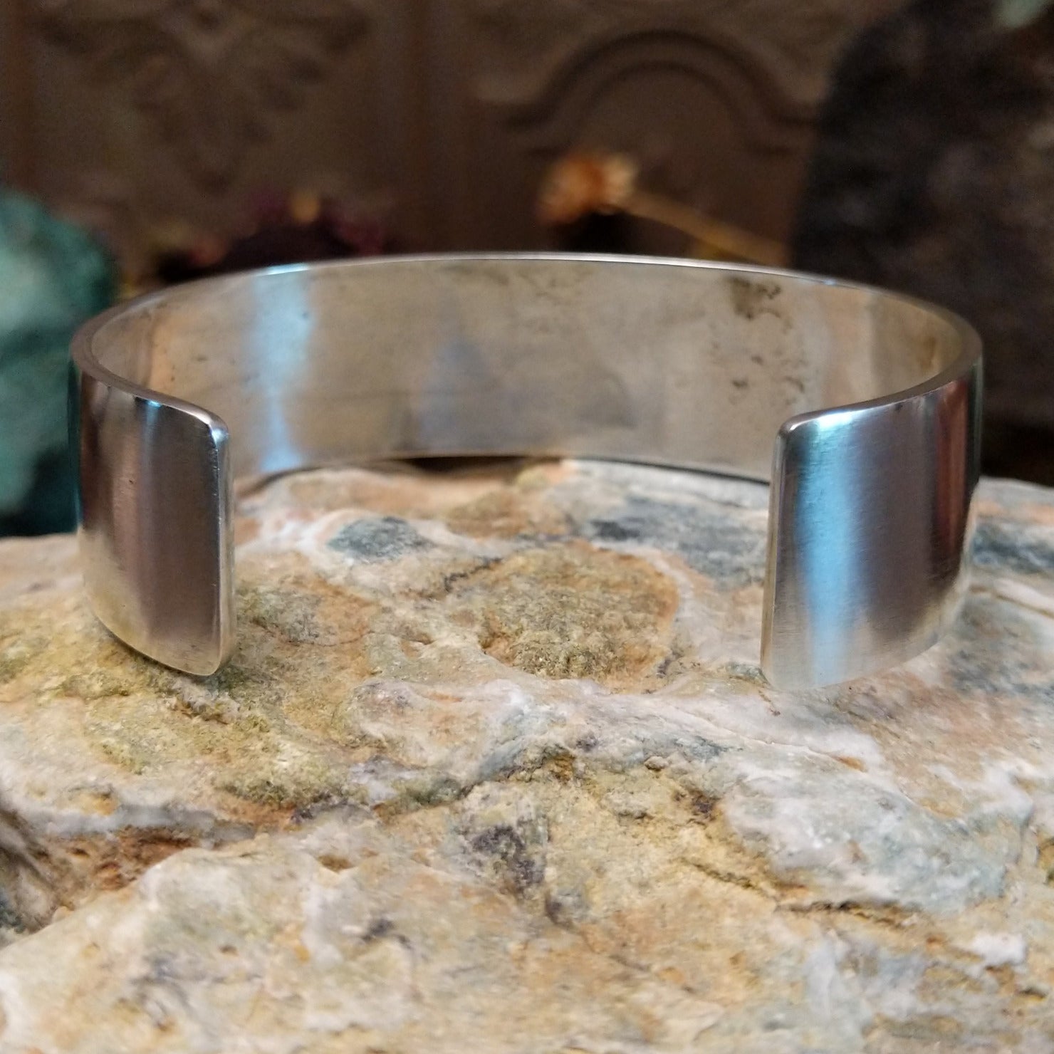 Handcrafted sterling silver cuff bracelet by Hopi artist Melinda Lucas featuring a carved Kokopelli design in a traditional Southwestern style. Underside view.