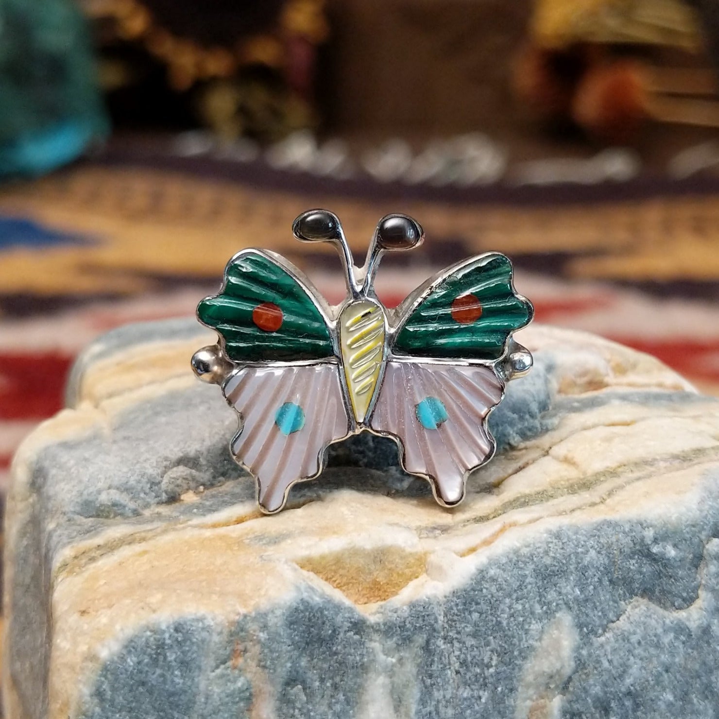 Handcrafted Zuni sterling silver butterfly ring featuring colorful multistone inlay work in a traditional Southwestern Native American design.