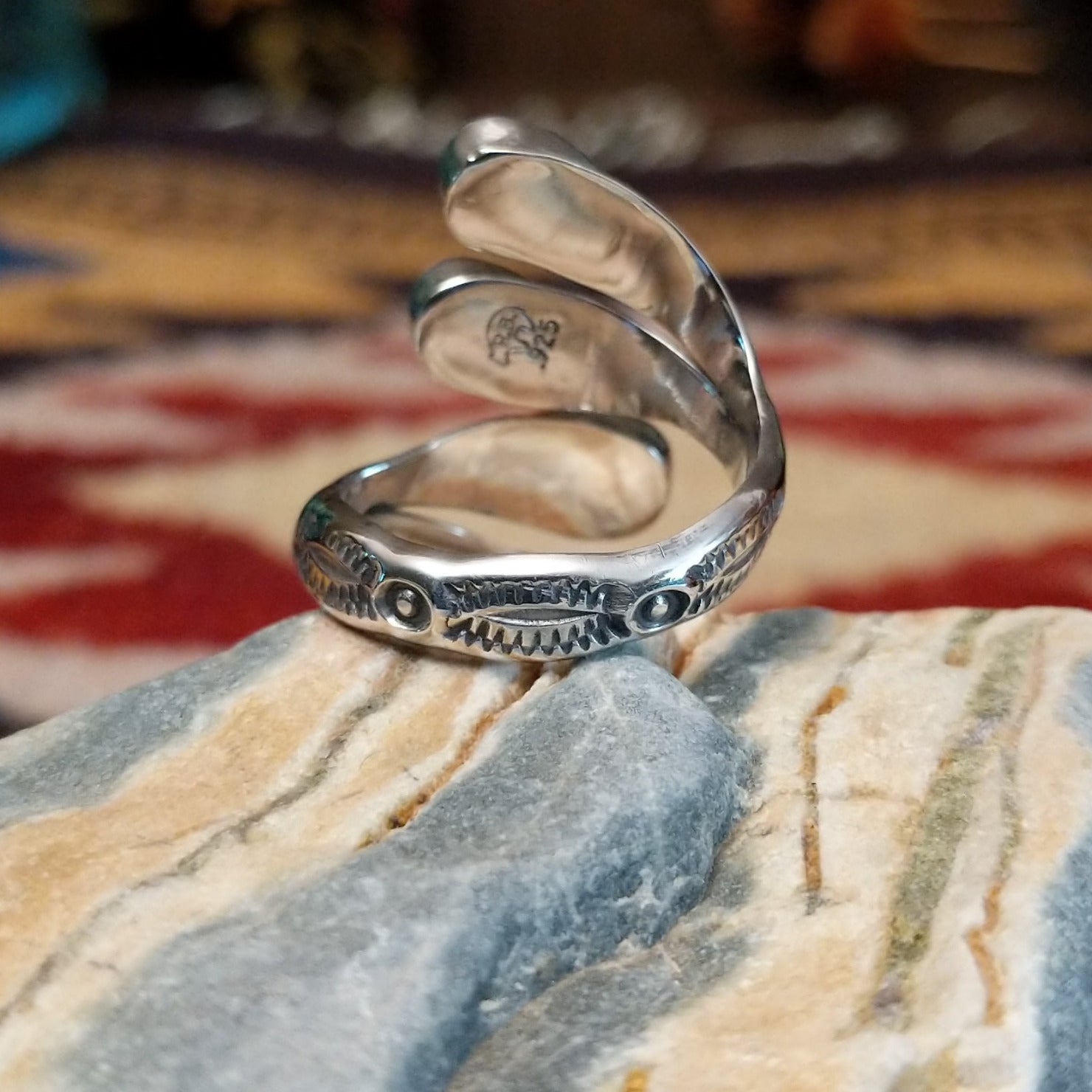 Handcrafted Navajo sterling silver teardrop ring featuring a white manmade opal with iridescent color play in a traditional Southwestern design. Underside view.
