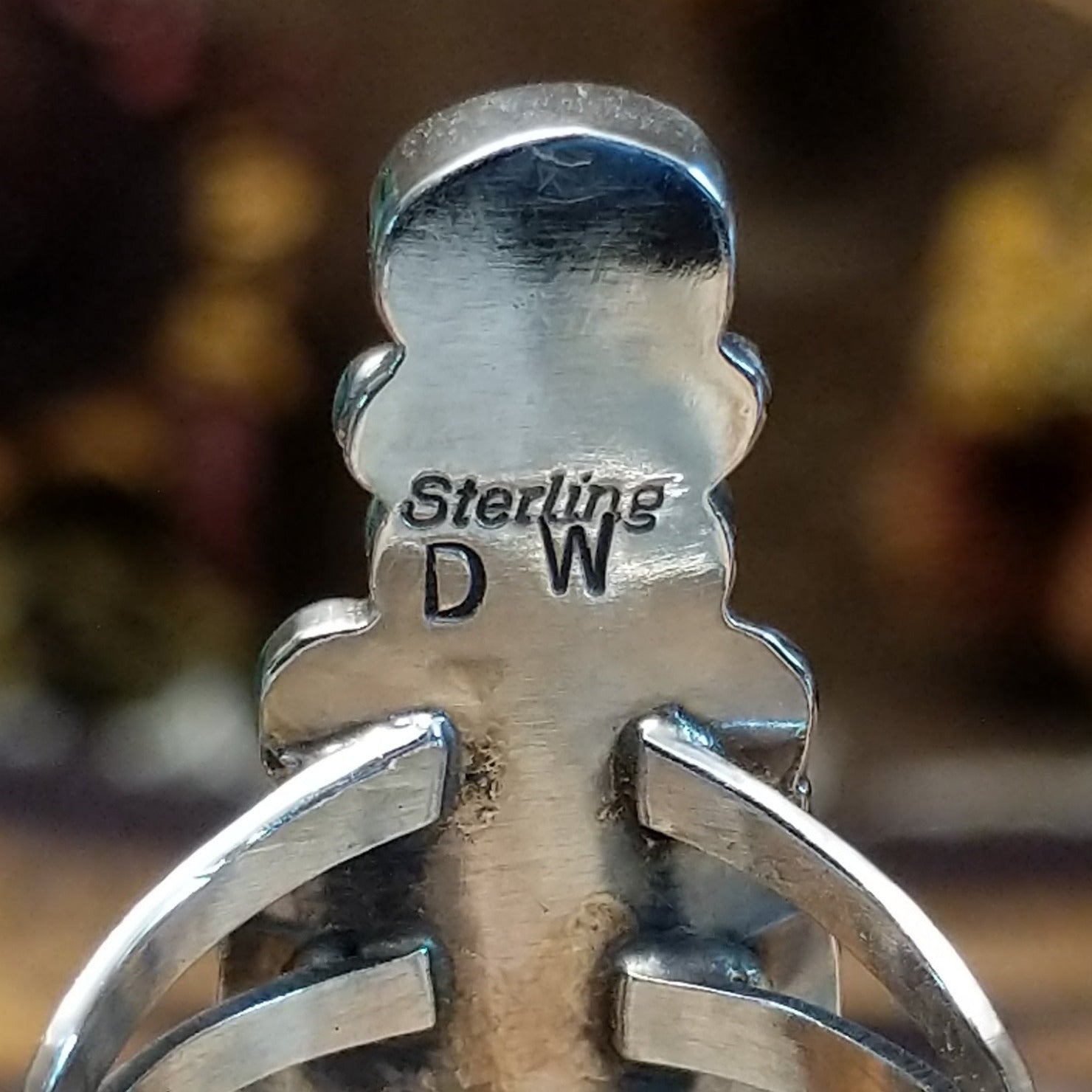 Handcrafted Navajo sterling silver ring by D.W. featuring multiple red coral stones arranged vertically with decorative silver scrollwork and traditional Southwestern detailing. Artisan and Sterling Silver stamp.