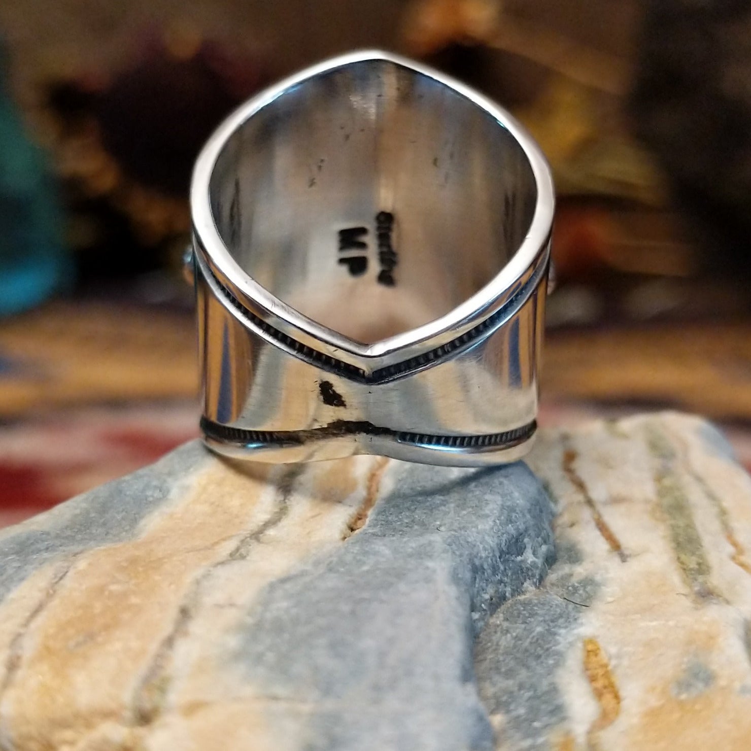 Handcrafted Navajo sterling silver ring by Murphy Platero featuring a raised oval turquoise stone surrounded by twisted wire, beadwork, and traditional Southwestern silver detailing. Underside view.