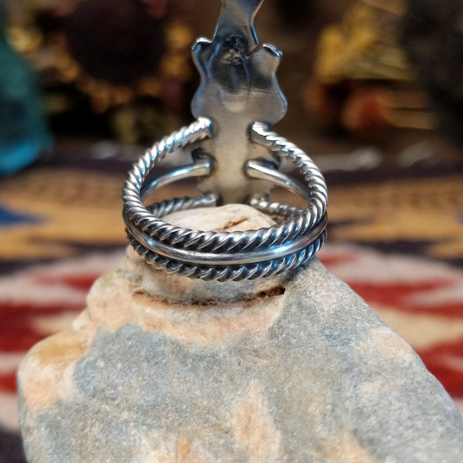 Handcrafted Navajo sterling silver ring featuring intricate silver detailing and traditional Southwestern craftsmanship in a bold regal design. Underside view.