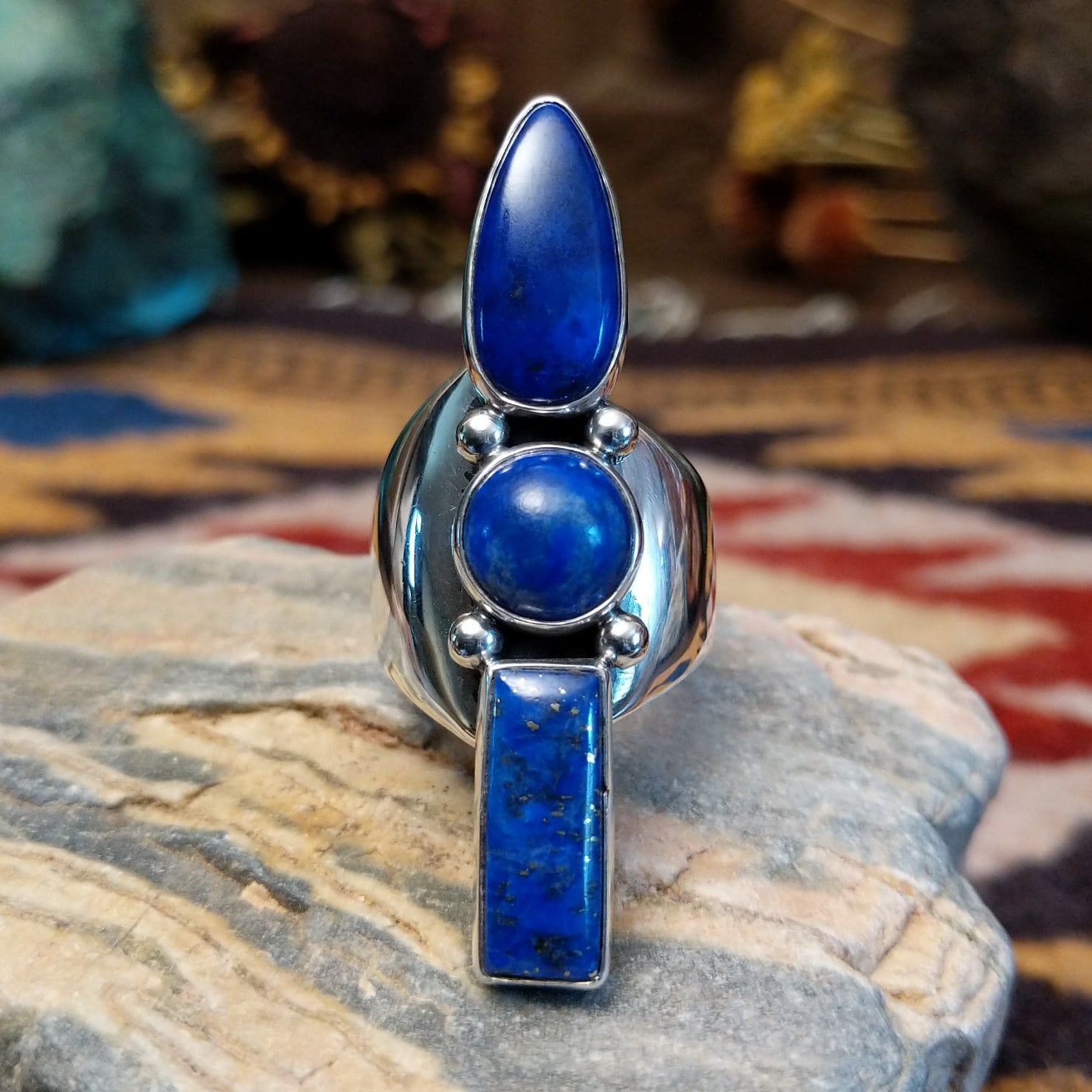 Handcrafted Navajo sterling silver ring by V.T. featuring a deep blue lapis stone in an abstract Southwestern design with intricate silver detailing.