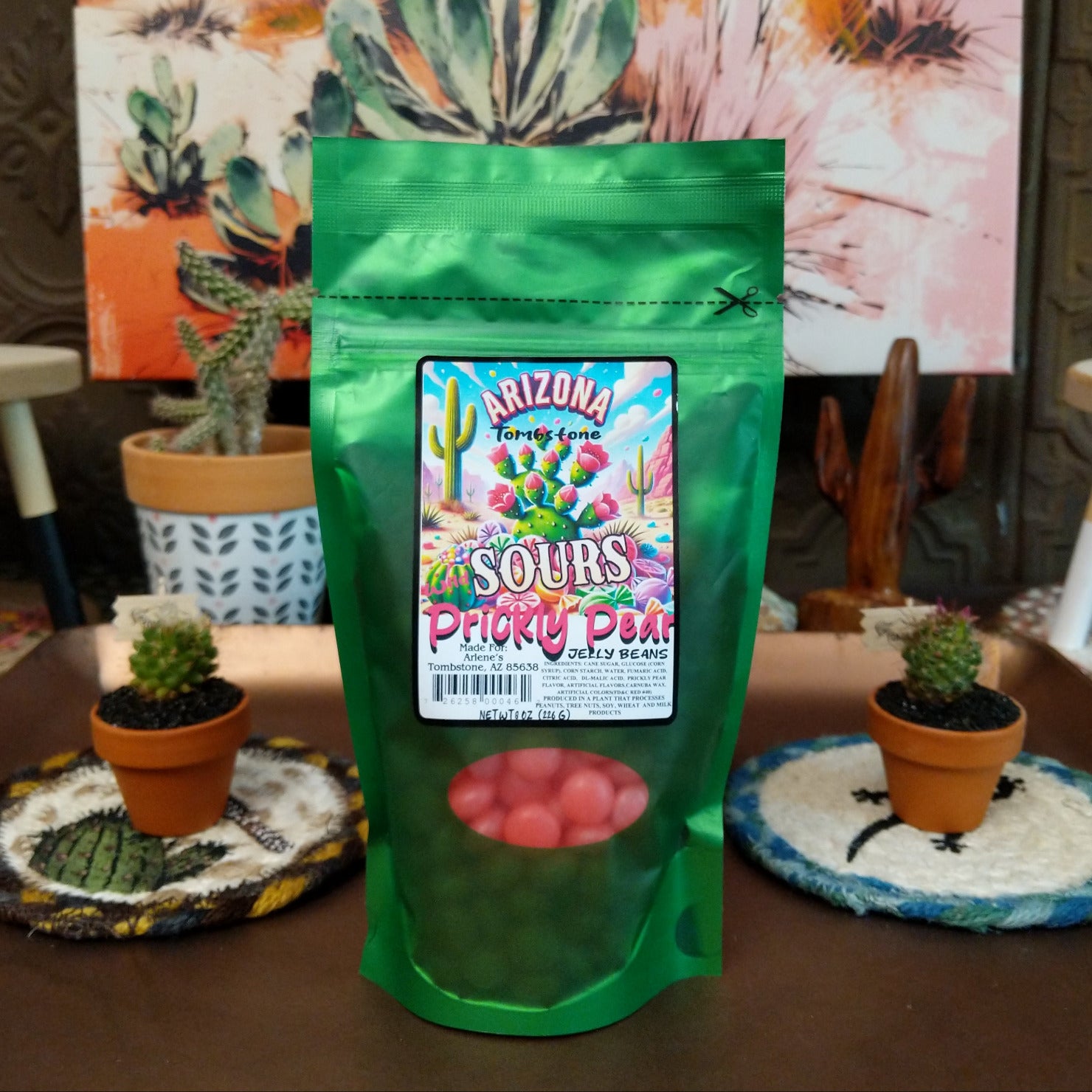 Bright sour prickly pear jelly beans with a sugary coating, displayed in a colorful pile. The candy features vibrant pink and purple tones and combines sweet prickly pear flavor with a tangy sour finish.