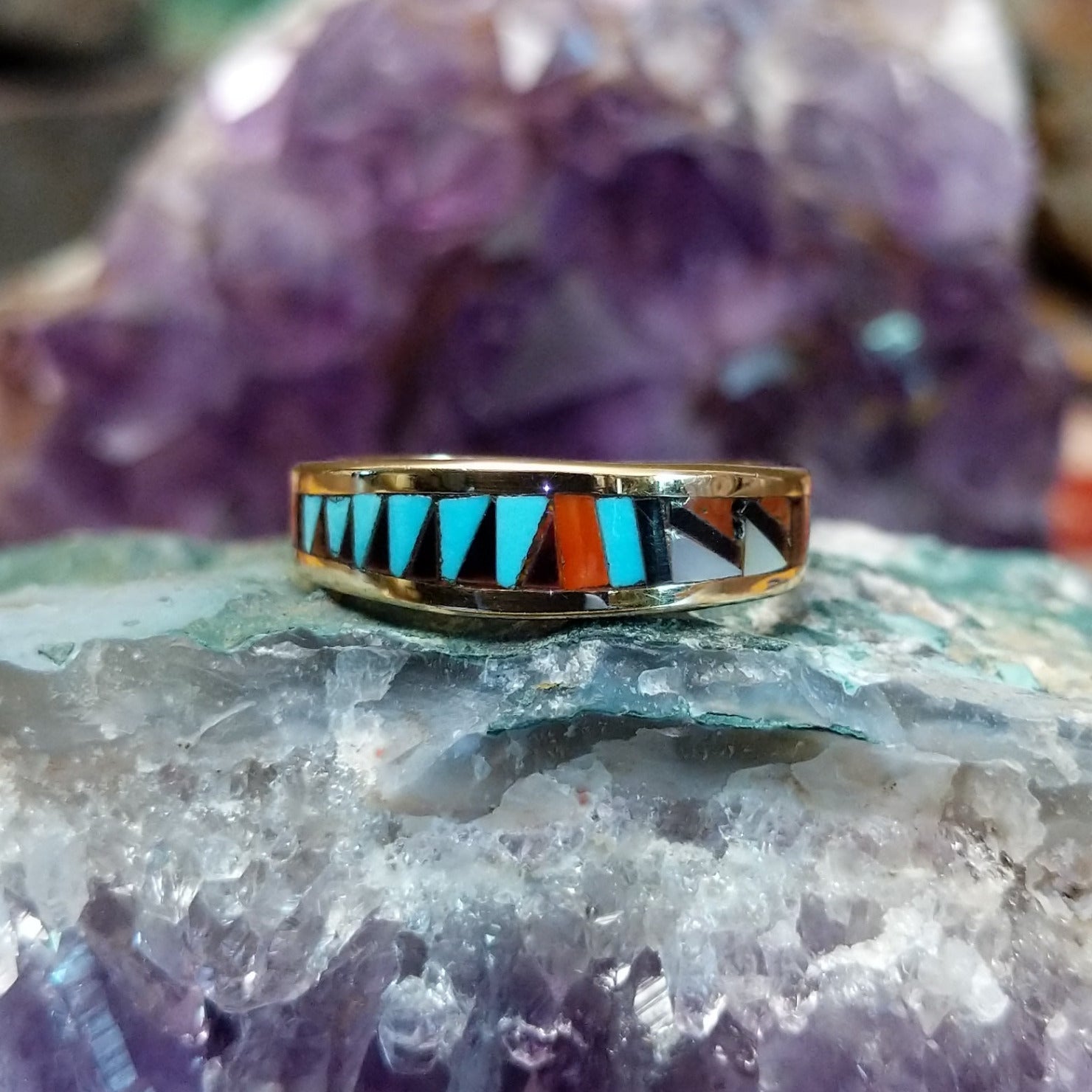 Zuni multistone inlay ring in 14K yellow gold by Charlotte Dishta, featuring precise geometric inlay work with multiple natural stones set into a polished gold band.