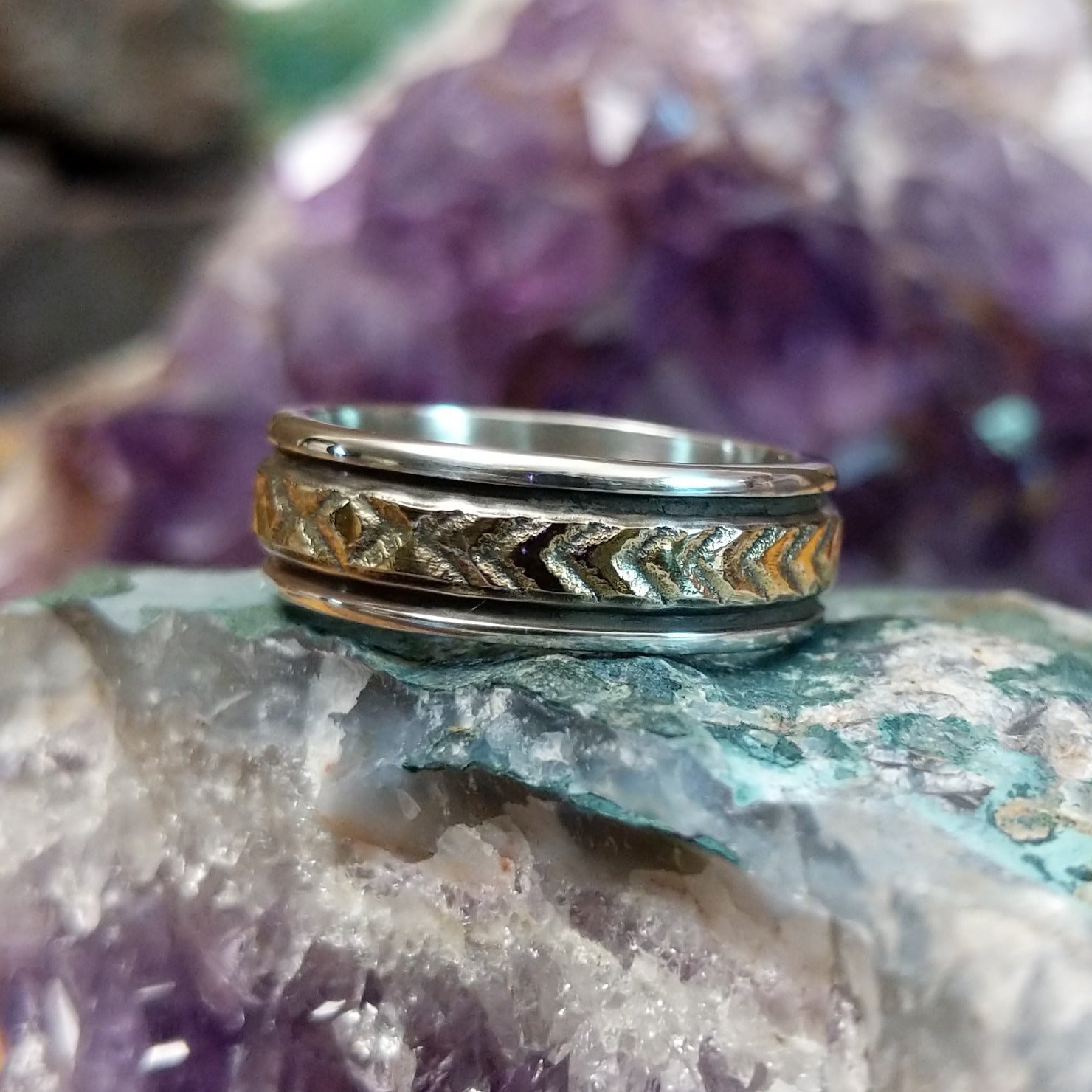 Silver and 14K gold stamped ring by Bruce Morgan, featuring handcrafted geometric stamp work, gold accents, and a polished sterling silver band.