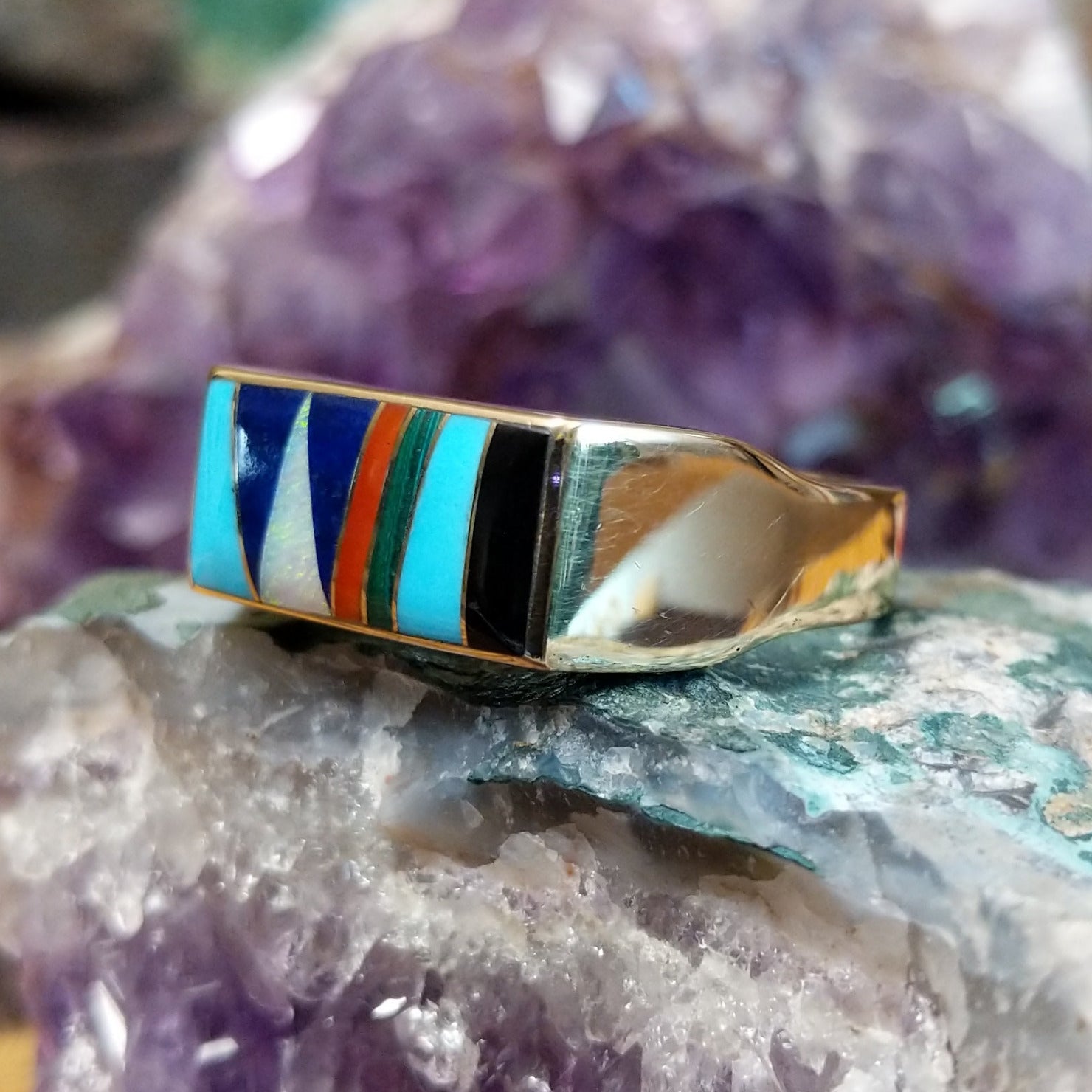 Multistone inlay ring in 14K yellow gold by Steve Francisco, featuring a vibrant mosaic of carefully fitted natural stones set within a polished gold band. Side view.