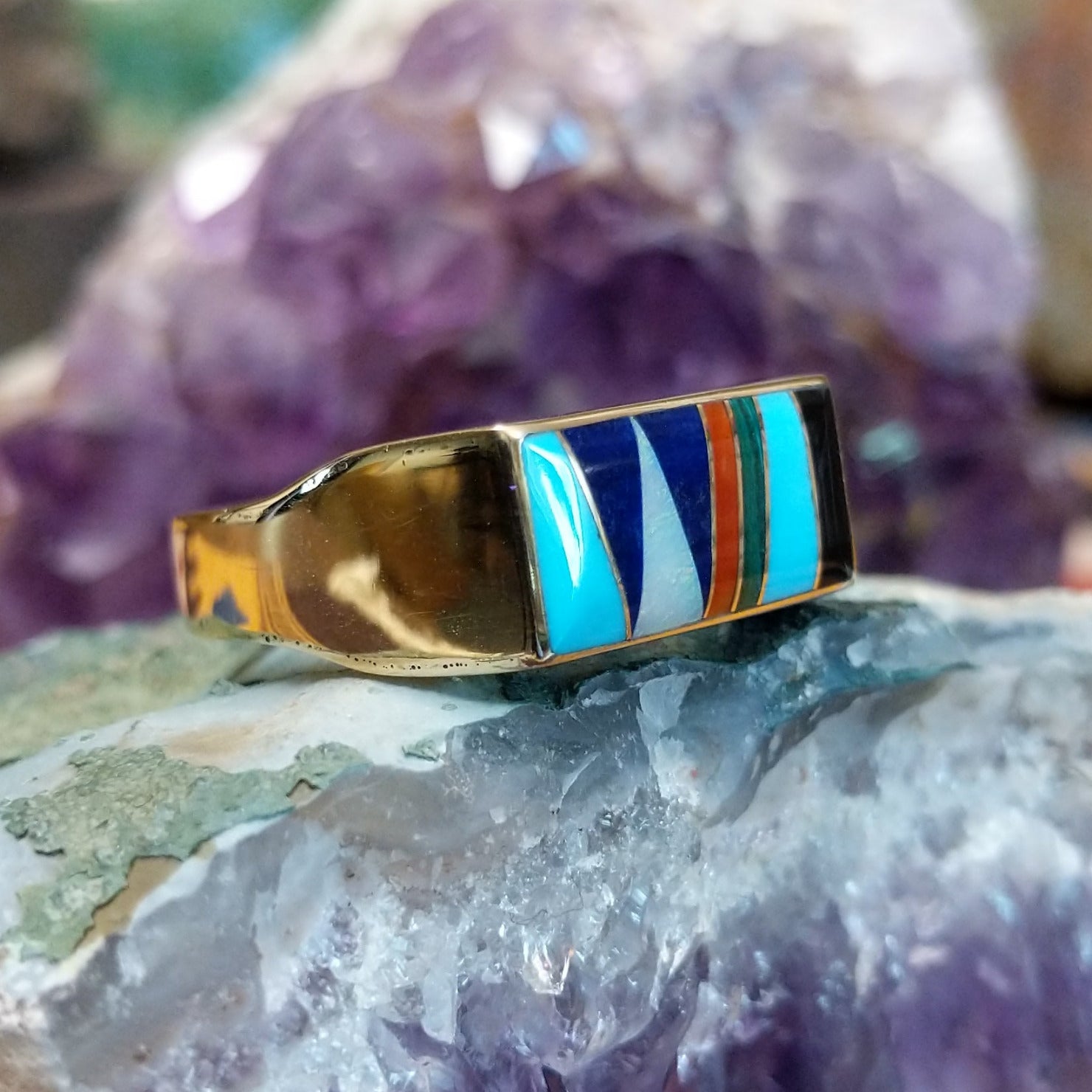 Multistone inlay ring in 14K yellow gold by Steve Francisco, featuring a vibrant mosaic of carefully fitted natural stones set within a polished gold band. Side view.