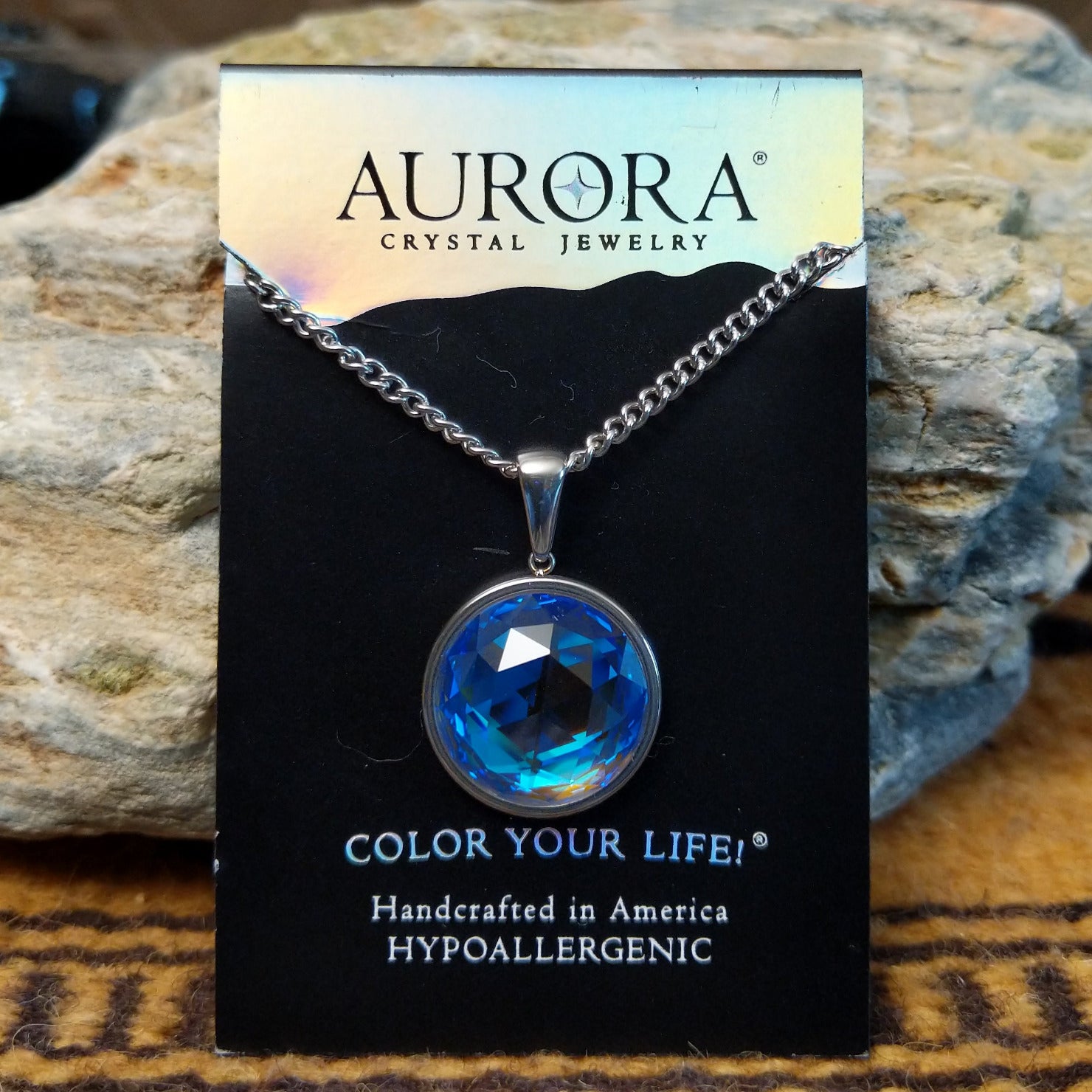 Aurora Eclipse crystal necklace by LeightWorks, featuring a sparkling faceted crystal pendant with brilliant light-reflecting detail on an elegant necklace chain.