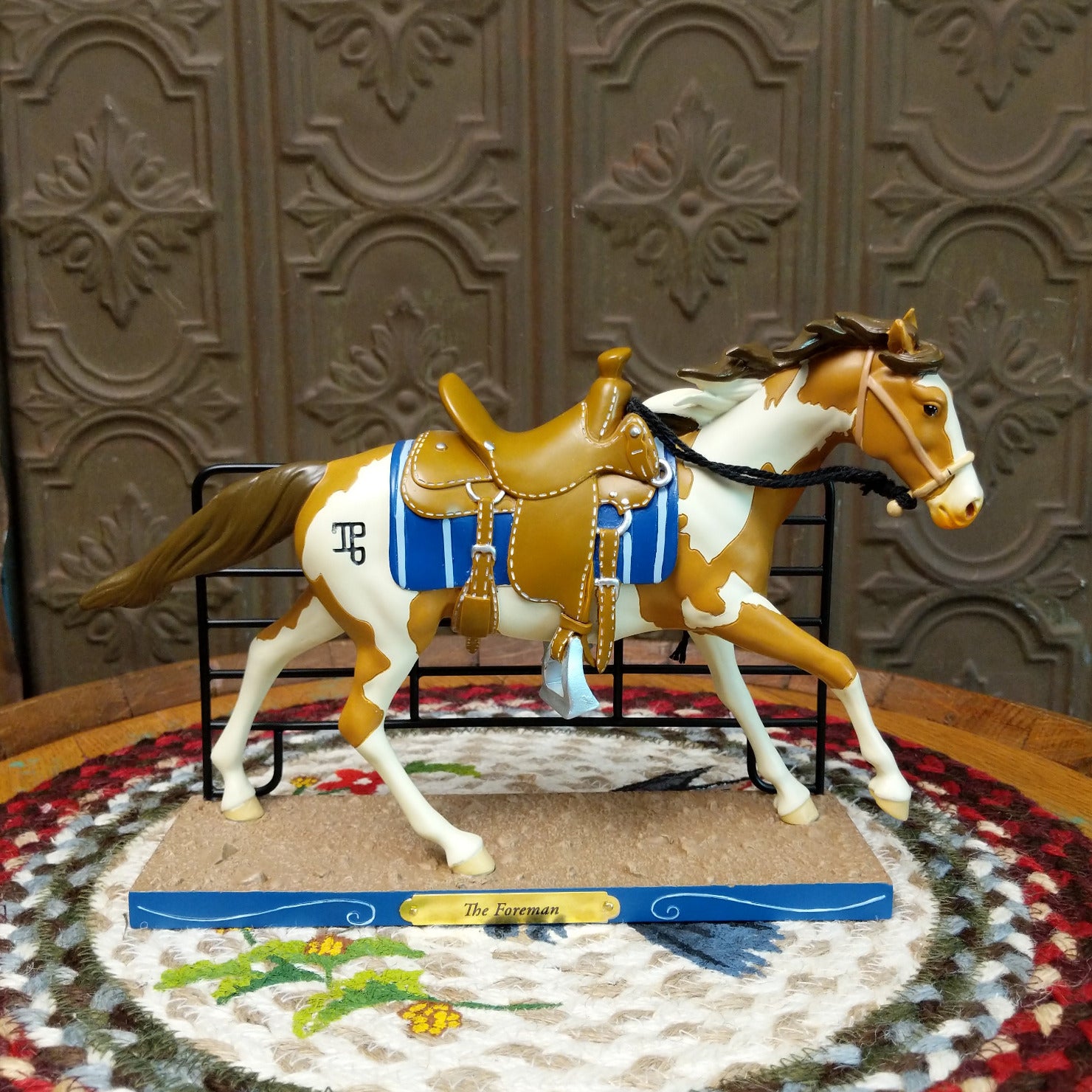 "The Foreman" collectible pony by The Trail of Painted Ponies, featuring detailed hand-painted Western-inspired artwork and ranching-themed design elements.