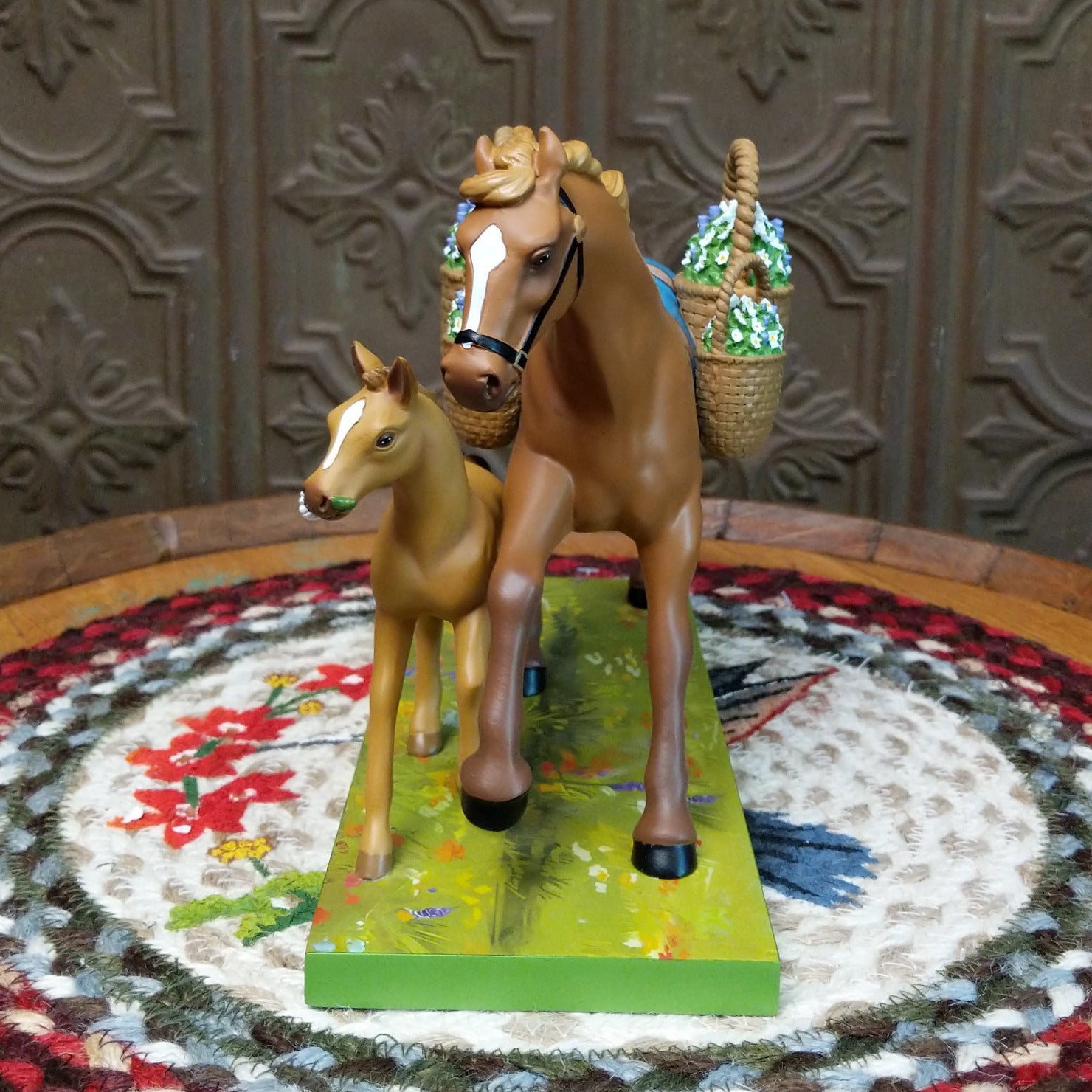 "Mama's Helper" collectible pony by The Trail of Painted Ponies, featuring detailed hand-painted artwork, vibrant colors, and family-inspired design elements. Front view.