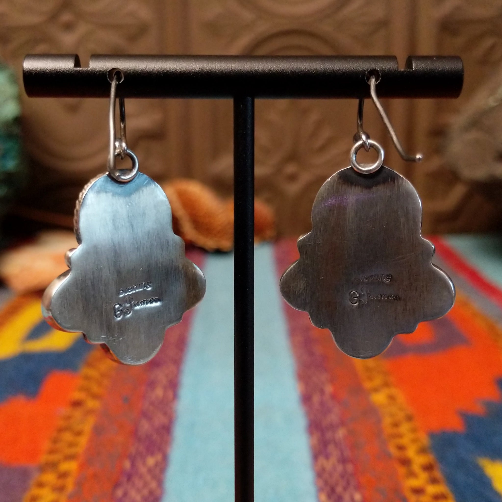 Palomino Variscite Sterling Silver earrings by Geraldine James, featuring white, cream, pale green, and yellow-green stones arranged in floral-style clusters; back side view with artisan and Sterling Silver stamps.