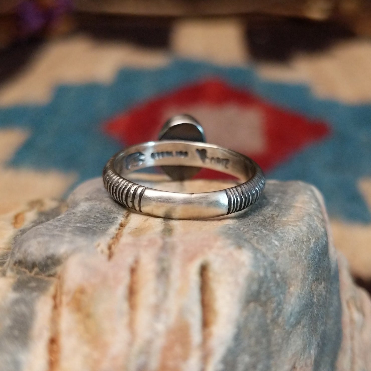 Sterling silver ring with turquoise set in the oval bezel and ribbed band.