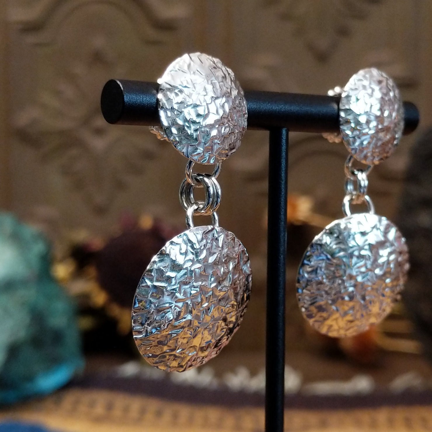 Sterling silver planished circle earrings featuring textured round dangles and matching textured stud tops.