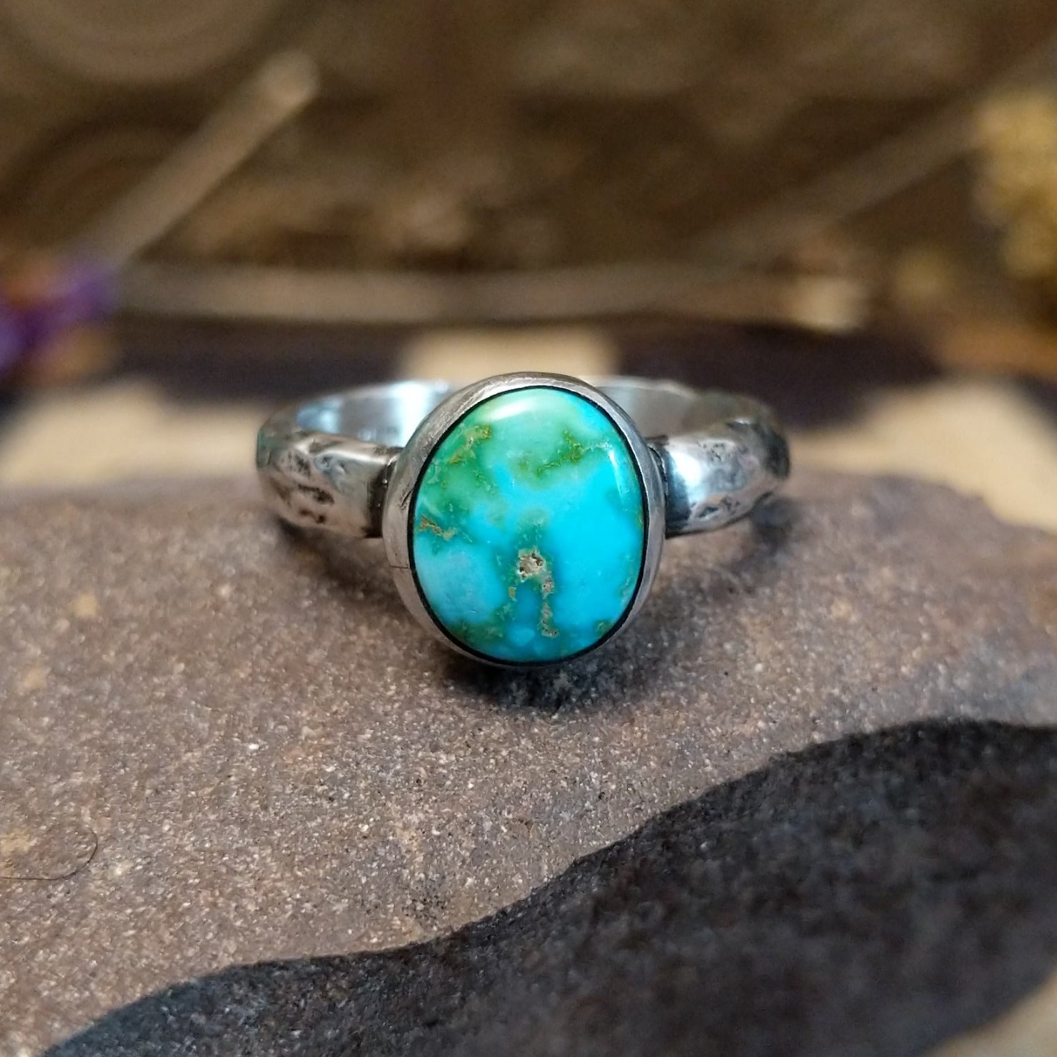 Sterling silver ring featuring Sonoran gold turquoise set in an round bezel with a planished finish.