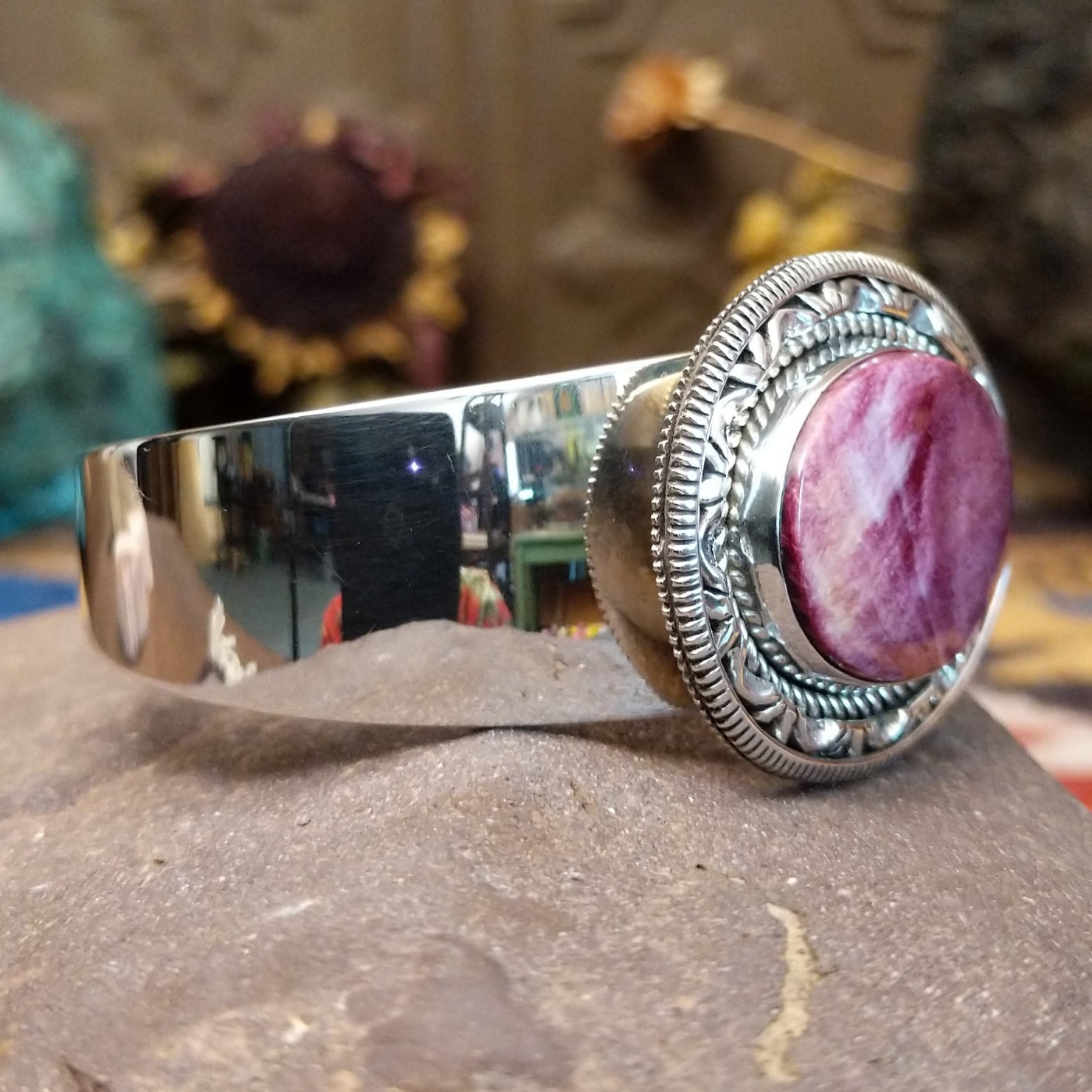 Sterling silver cuff featuring purple spiny oyster shell set in a twisted rope bezel.