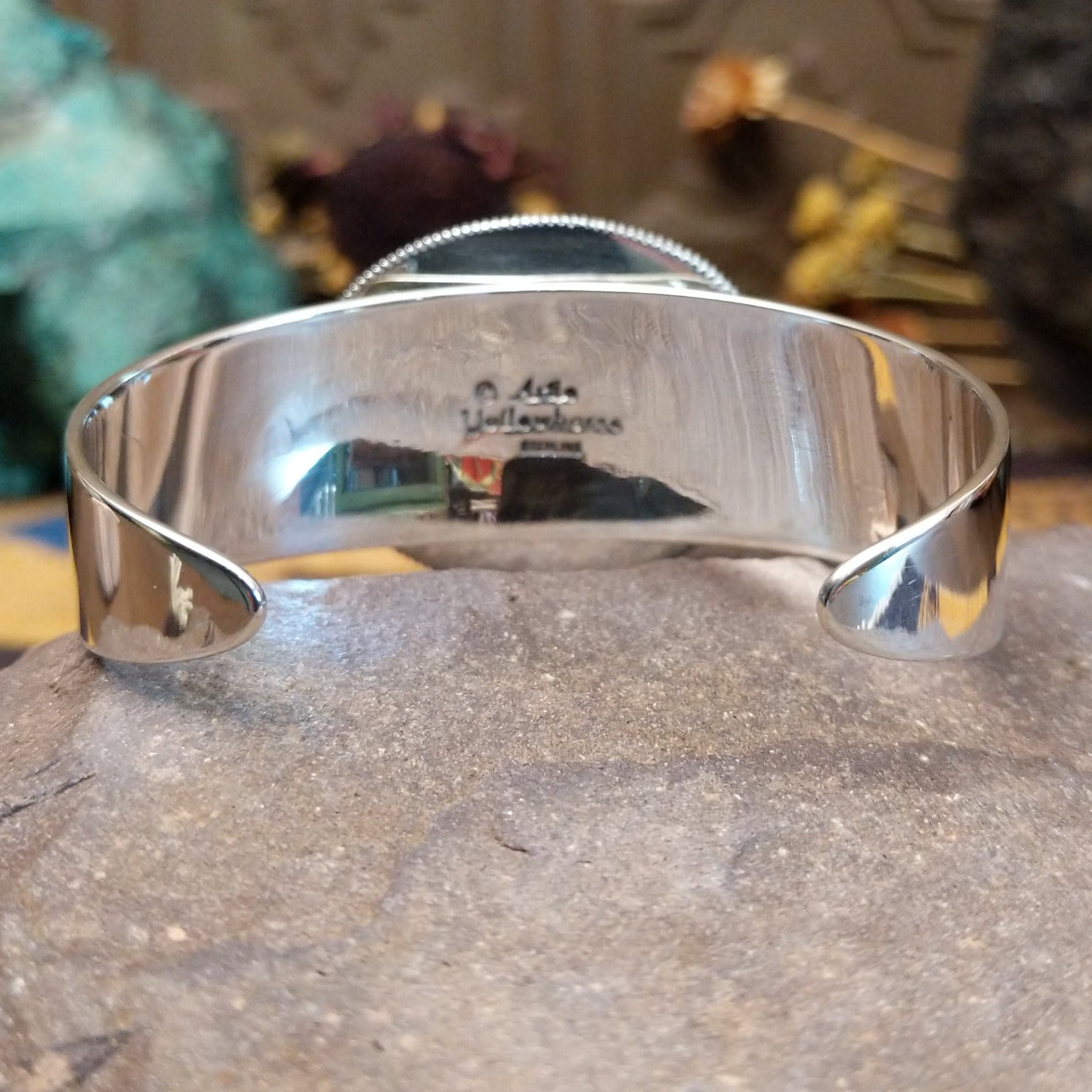 Sterling silver cuff featuring purple spiny oyster shell set in a twisted rope bezel.
