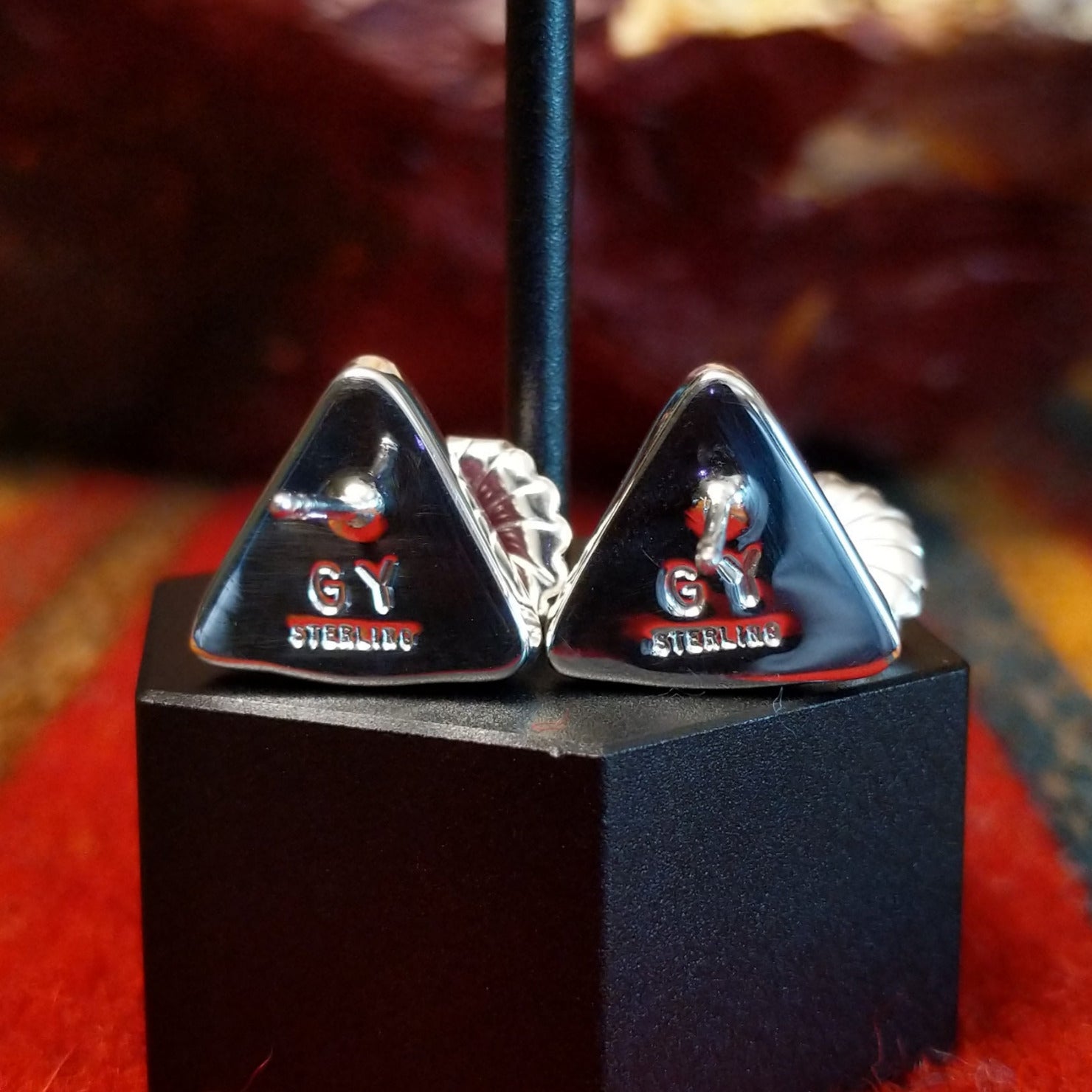 The backings are stamped with the artisan's initials.