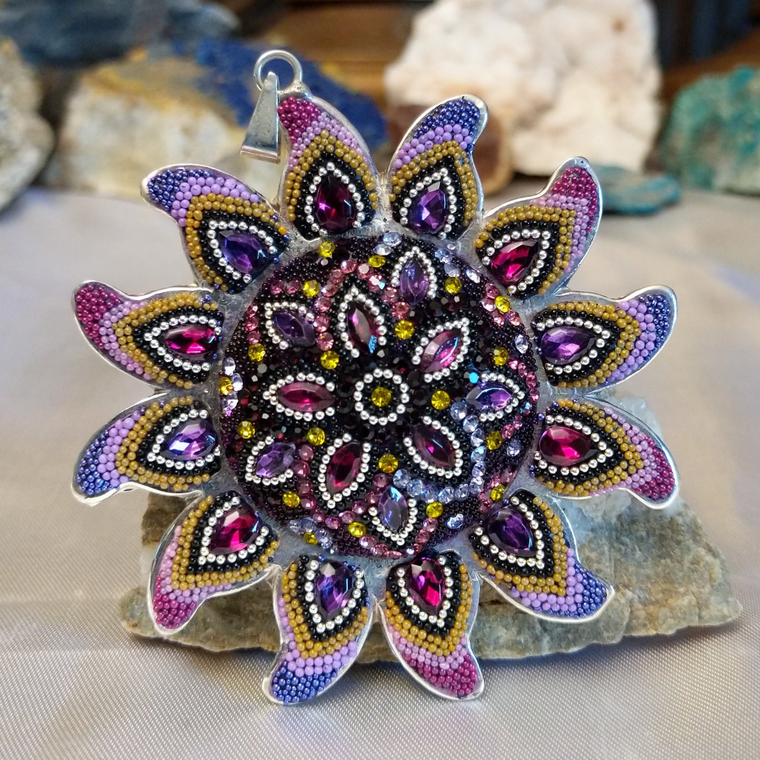 Sterling silver sun necklace set with rainbow colored Austrian crystal.