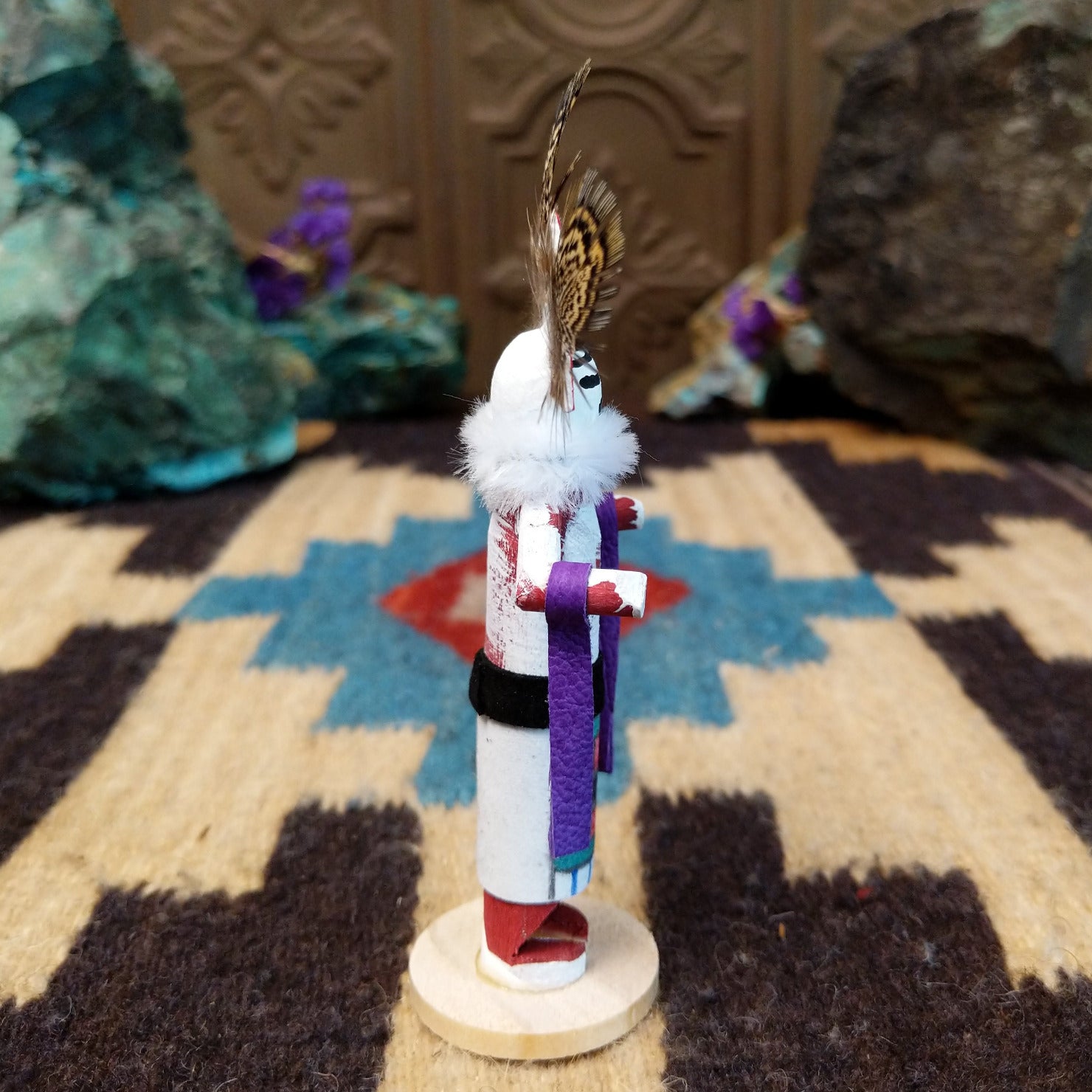 Mini rainbow kachina by Rosalind Grey with multicolored rainbow headdress, patterned feathers, white face, and feather collar.