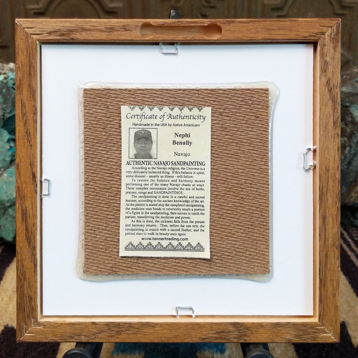 Backside of the Rainbow Yei sand painting, showing the Certificate of Authenticity and Artist information.