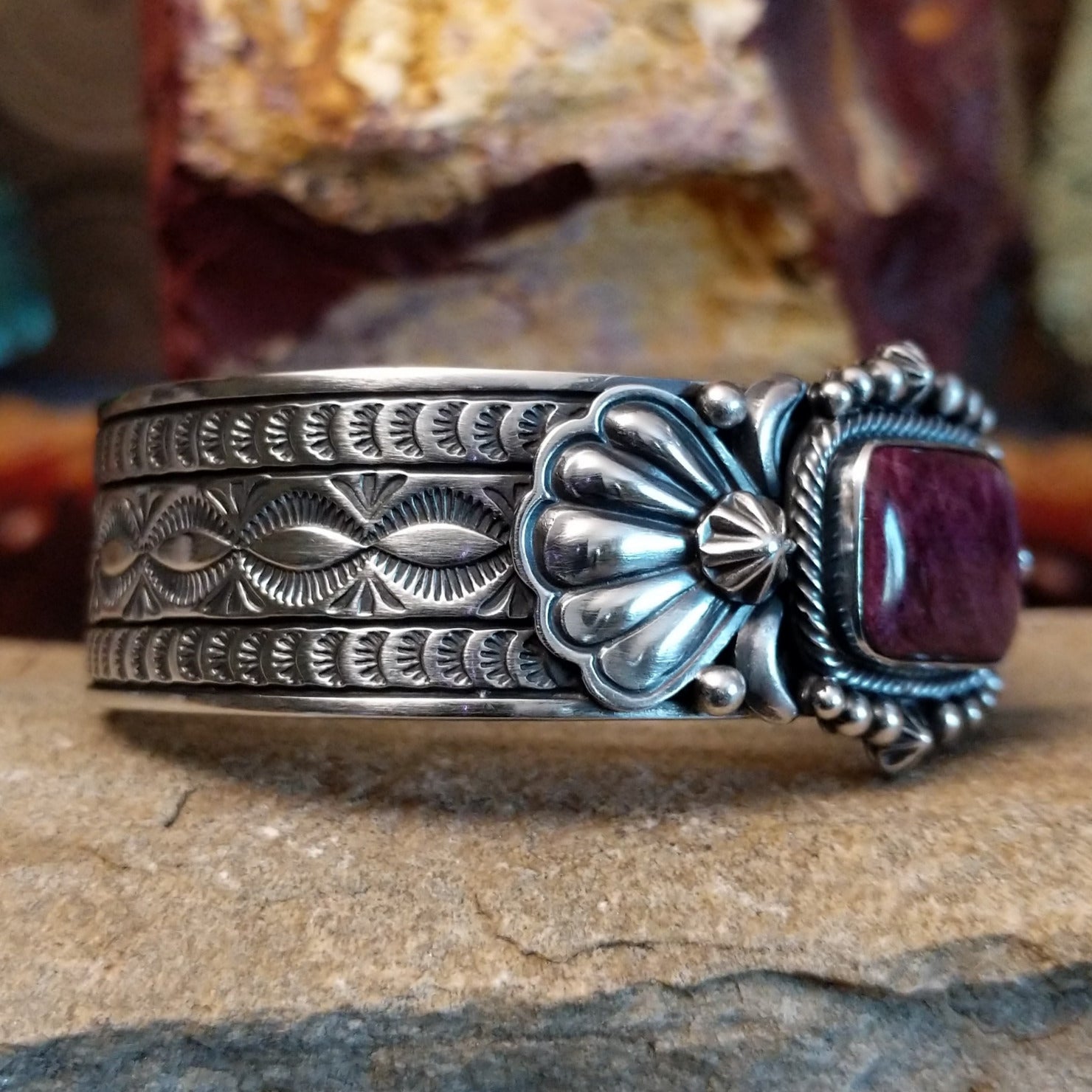 A rectangular purple spiny oyster shell cuff set in detailed sterling silver and ornate band.
