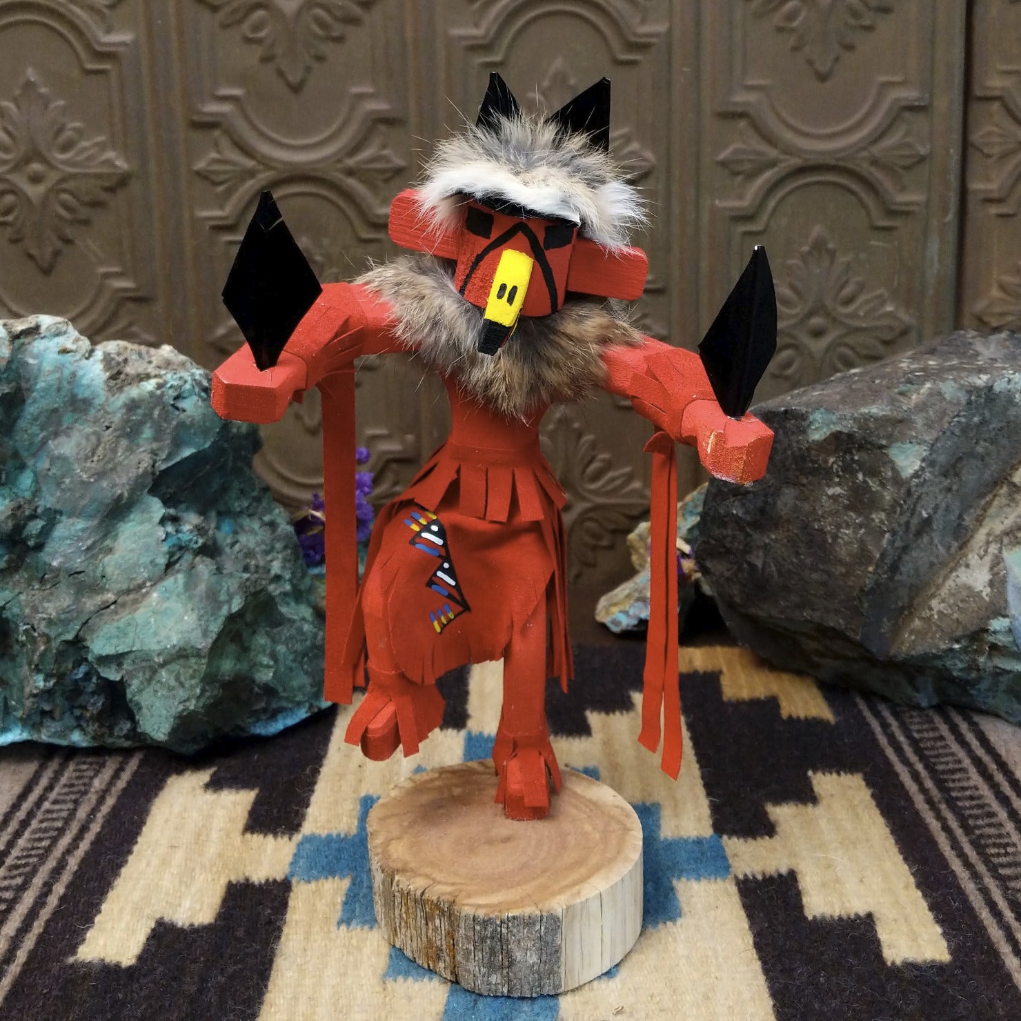 Navajo-made redtail hawk kachina doll by M. C. in red with raised leg, yellow beak, and fur collar.
