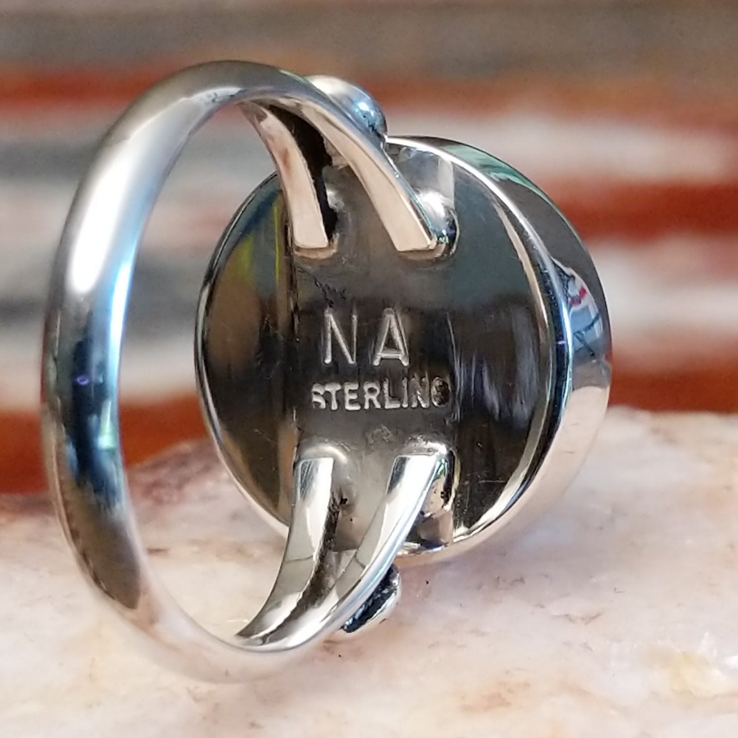 Close-up of the artisan's stamped initials.