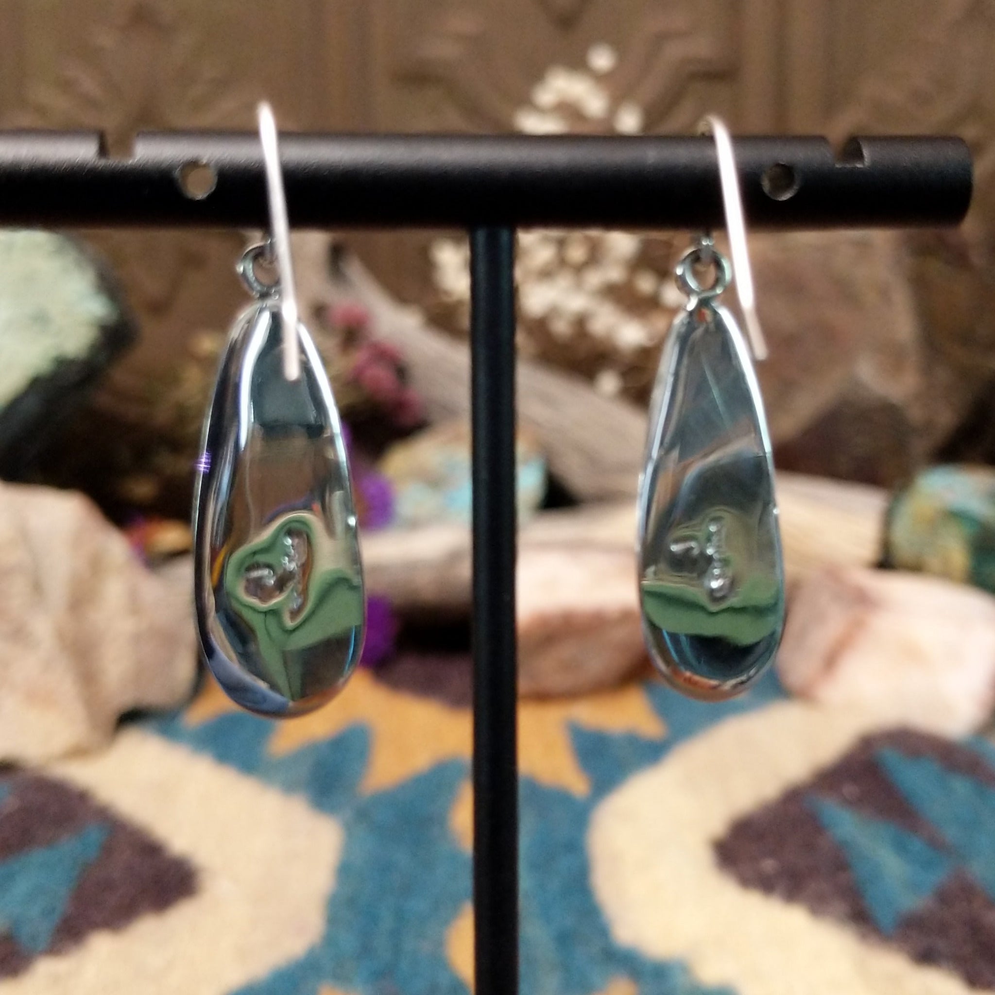 Handcrafted sterling silver teardrop earrings by John King featuring natural rhodochrosite with soft pink and white banding in hand-stamped sterling silver settings on French hooks; artisan and Sterling Silver stamp.