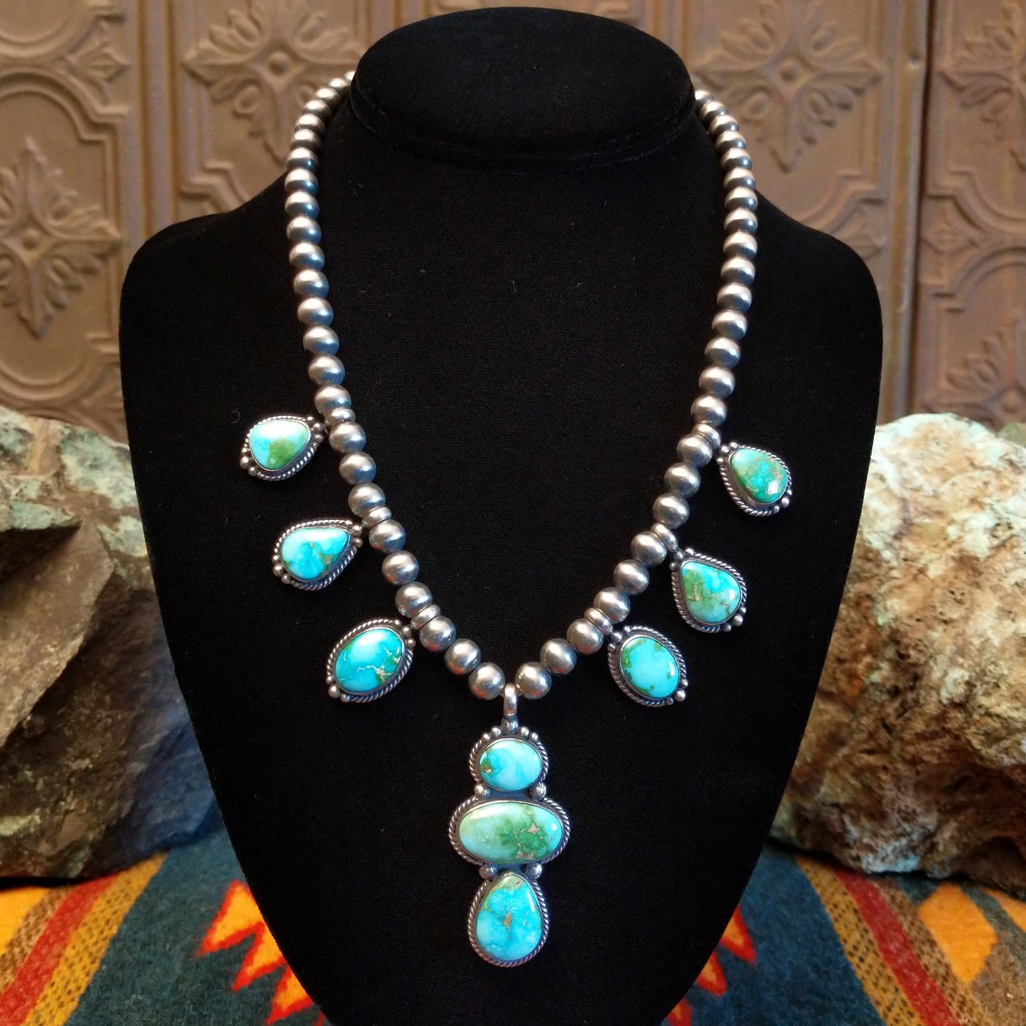 Necklace with Sonoran Gold turquoise spaced along the beaded silver chain, the bezels are framed by twisted rope and dotted accents.