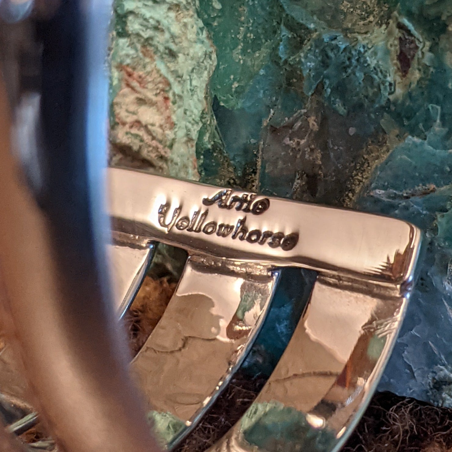 Close-up of the artisan's stamped signature.