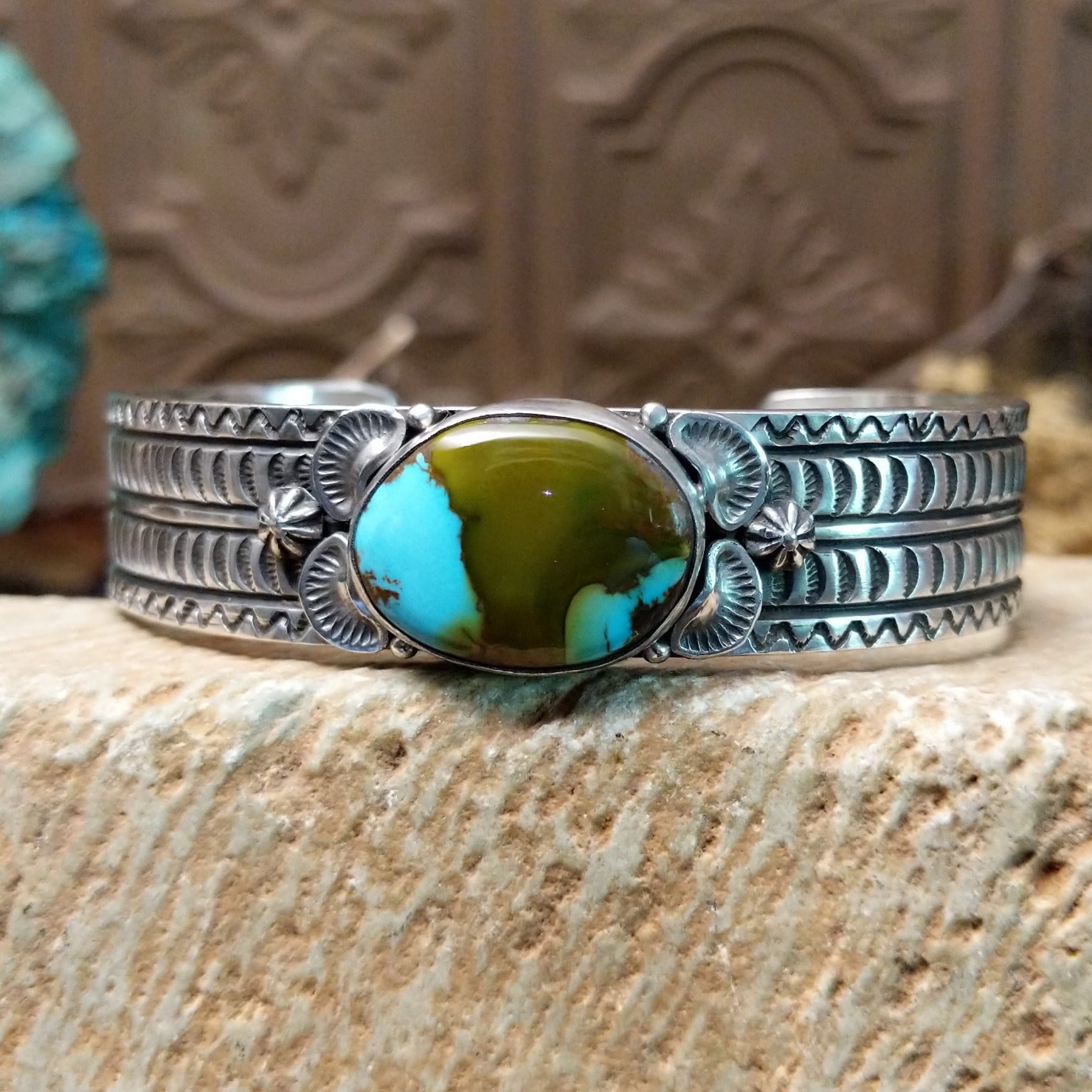 Sterling silver cuff with Royston turquoise set in the oval bezel and geometric stamping on the band.