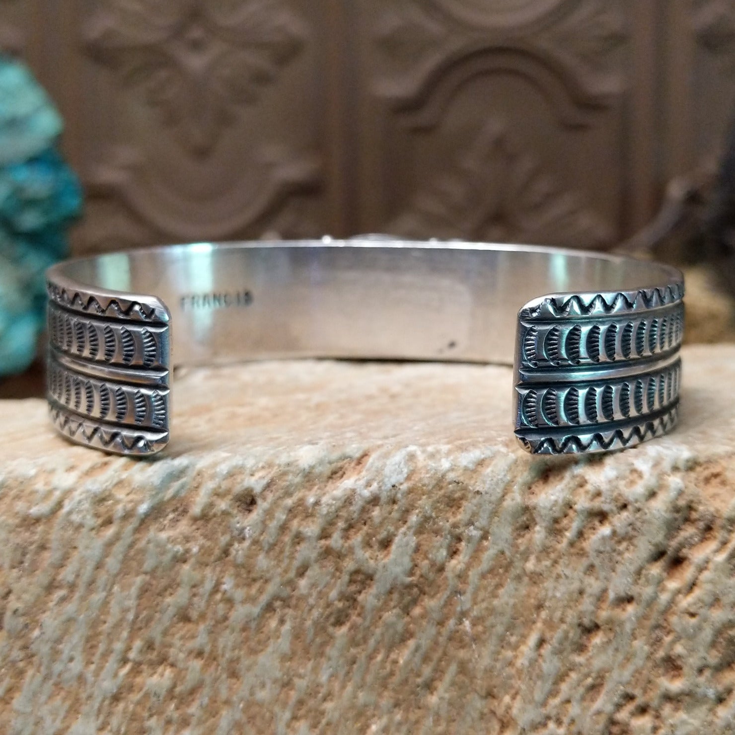 Sterling silver cuff with Royston turquoise set in the oval bezel and geometric stamping on the band.
