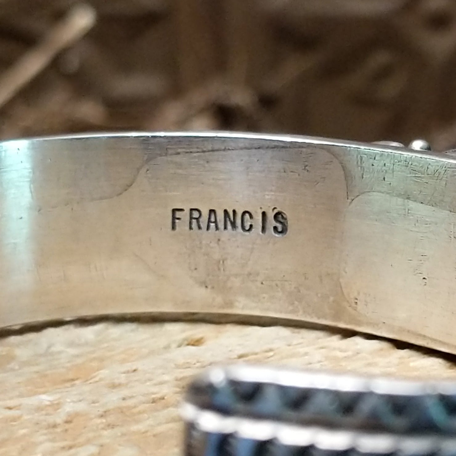Close-up of the artisan's stamped signature.