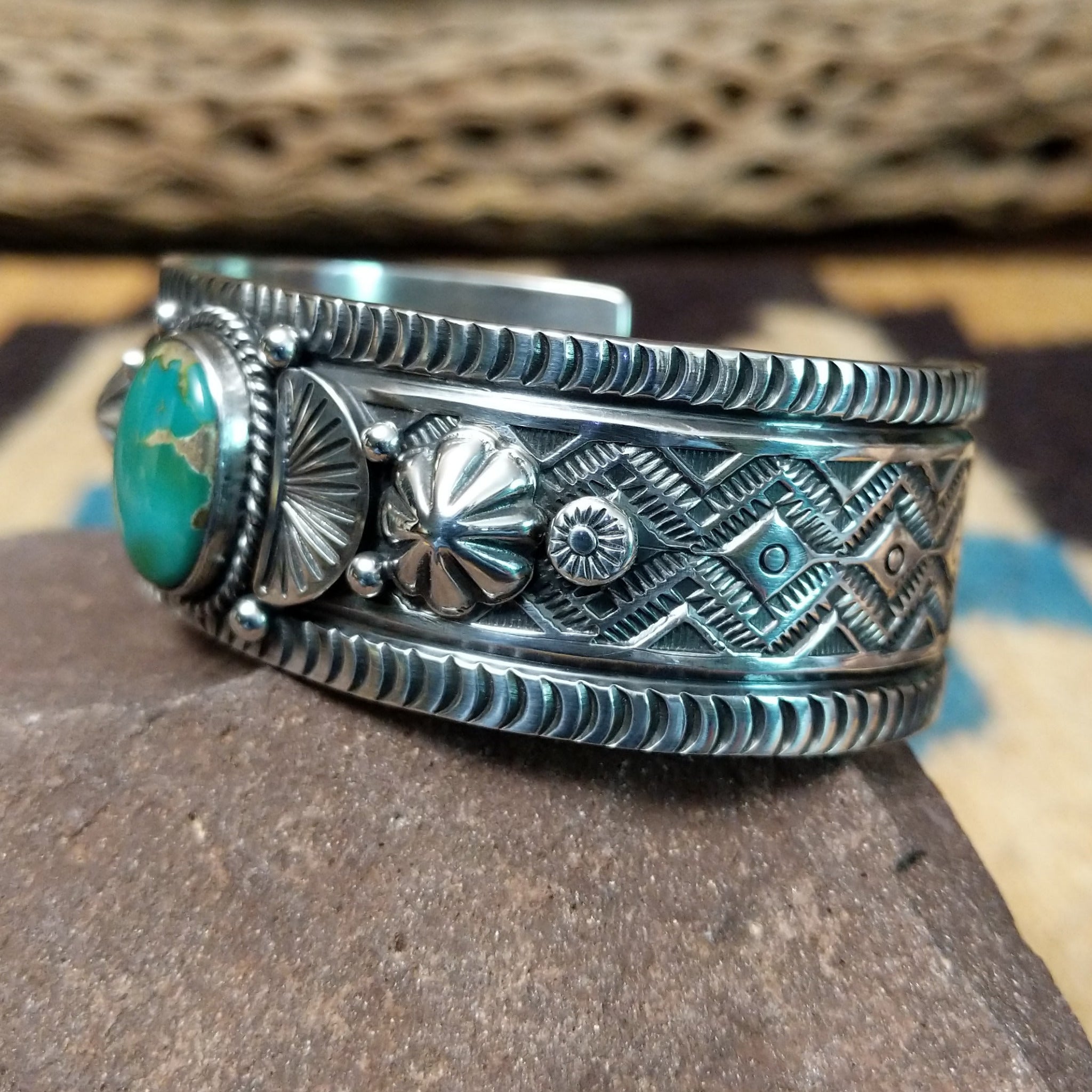 Royston turquoise cuff by Murphy Platero, featuring a vibrant blue and green Royston turquoise stone with natural matrix set in a handcrafted sterling silver open cuff. Side view.