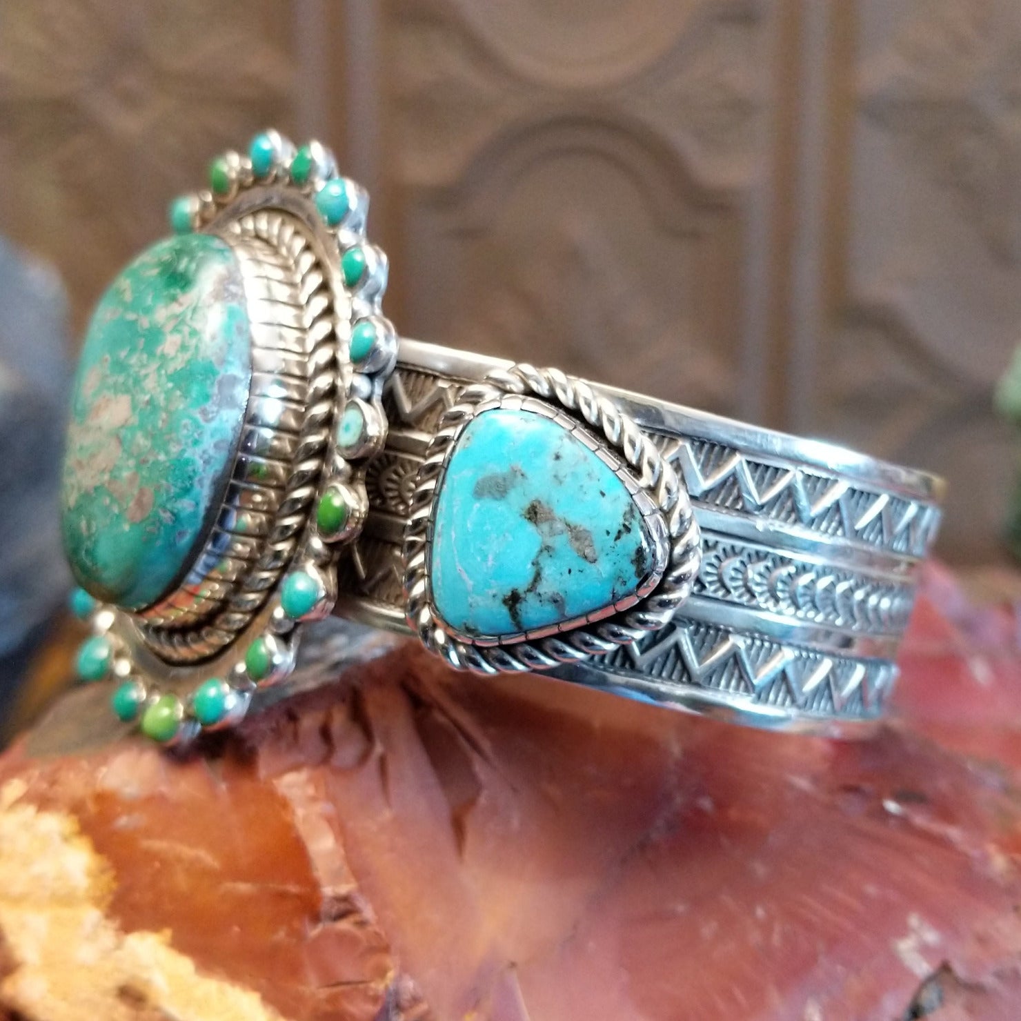 Large sterling silver cuff bracelet with Royston turquoise set in large bezels, framed by stamping and twisted rope designs.