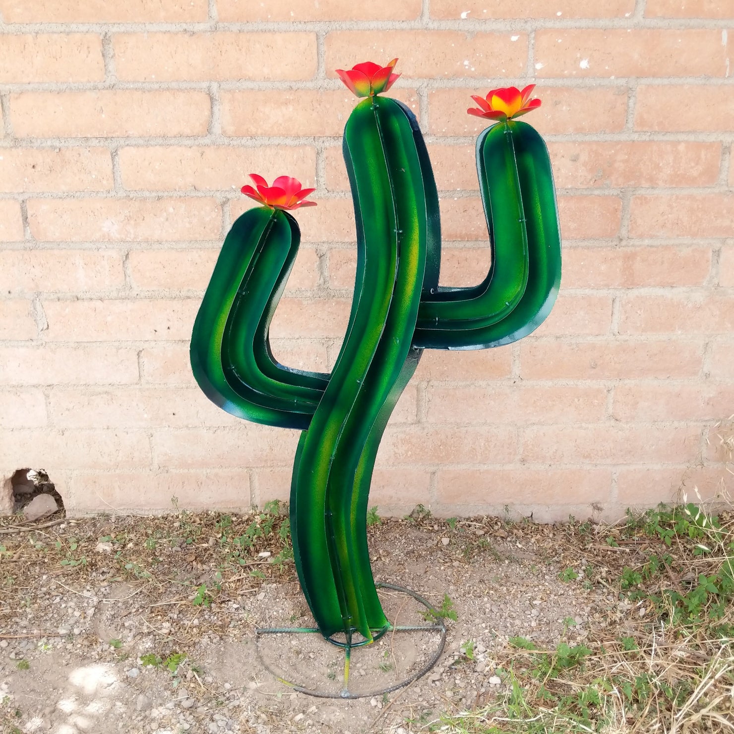 Medium saguaro metal art piece featuring a vibrant green cactus with yellow streaks and red flowers.