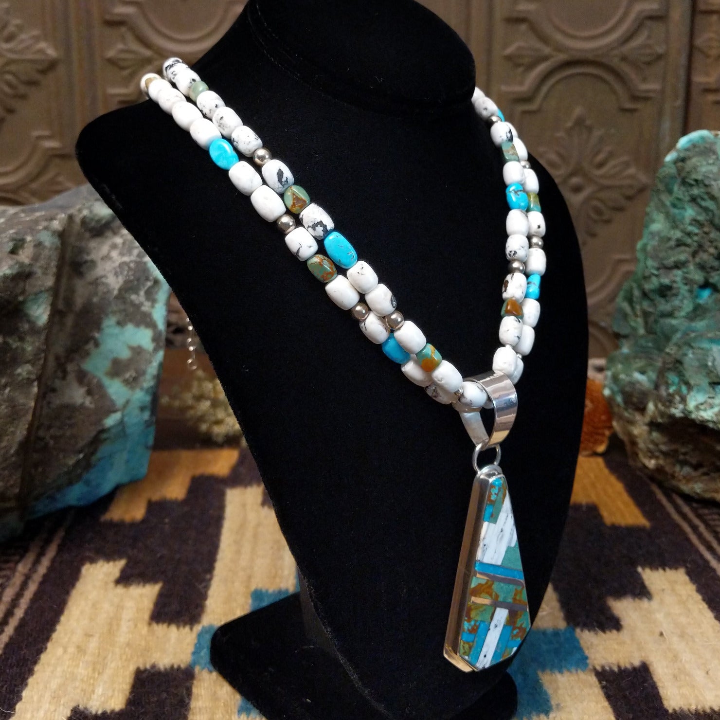Sterling silver necklace with turquoise and white buffalo beaded along the chain and inlaid on the pendant.