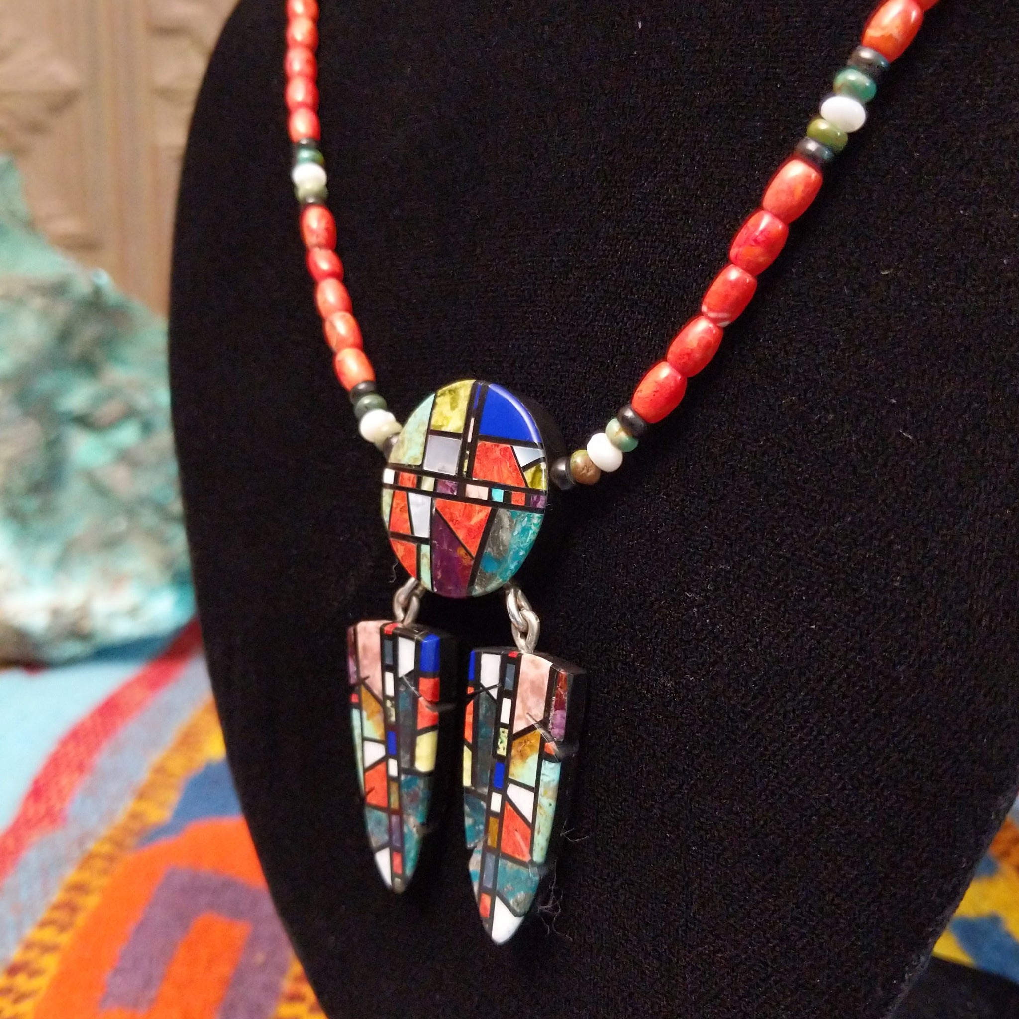 Red-orange bead necklace with a round multistone mosaic centerpiece and two matching dangling mosaic pendants