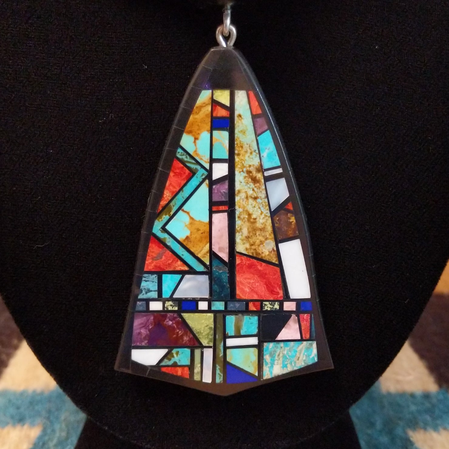 Sterling silver necklace featuring beaded strands and multistone inlay on the pendant.